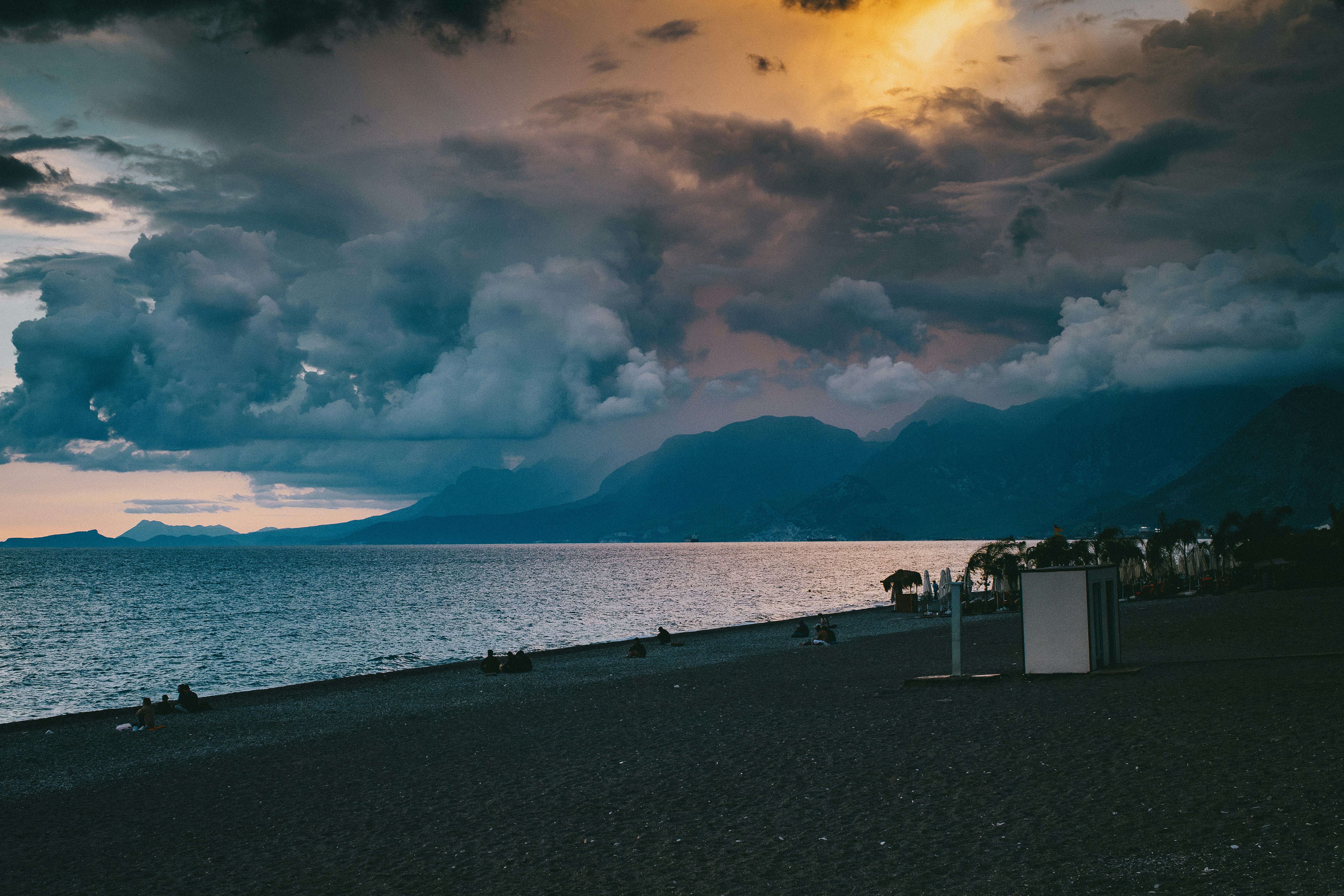 Pebble beach under dramatic cloudy sky - Free Photo on Unsplash