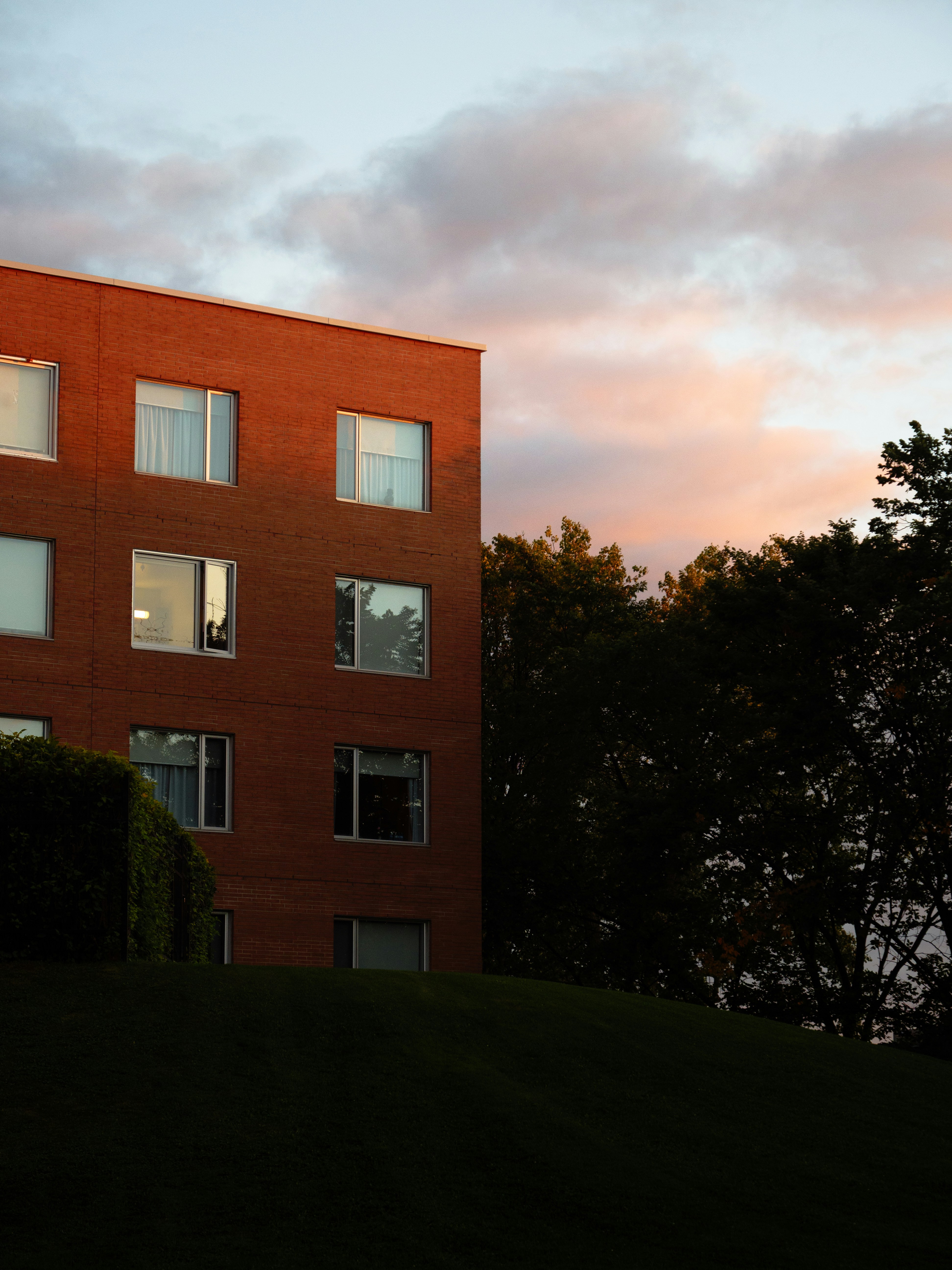 Red brick building under pink sky - Free Photo on Unsplash