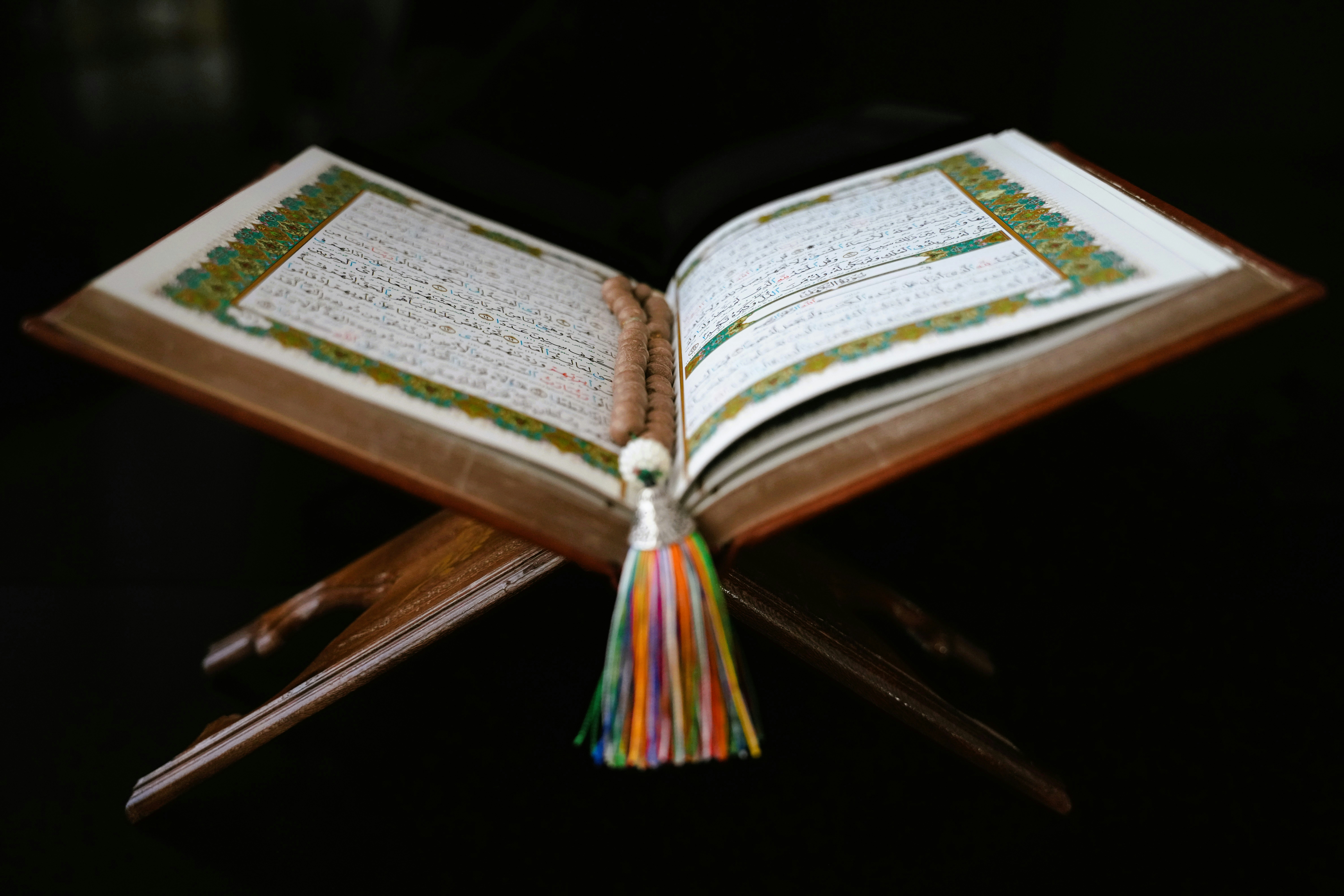 An open Quran on a wooden stand
