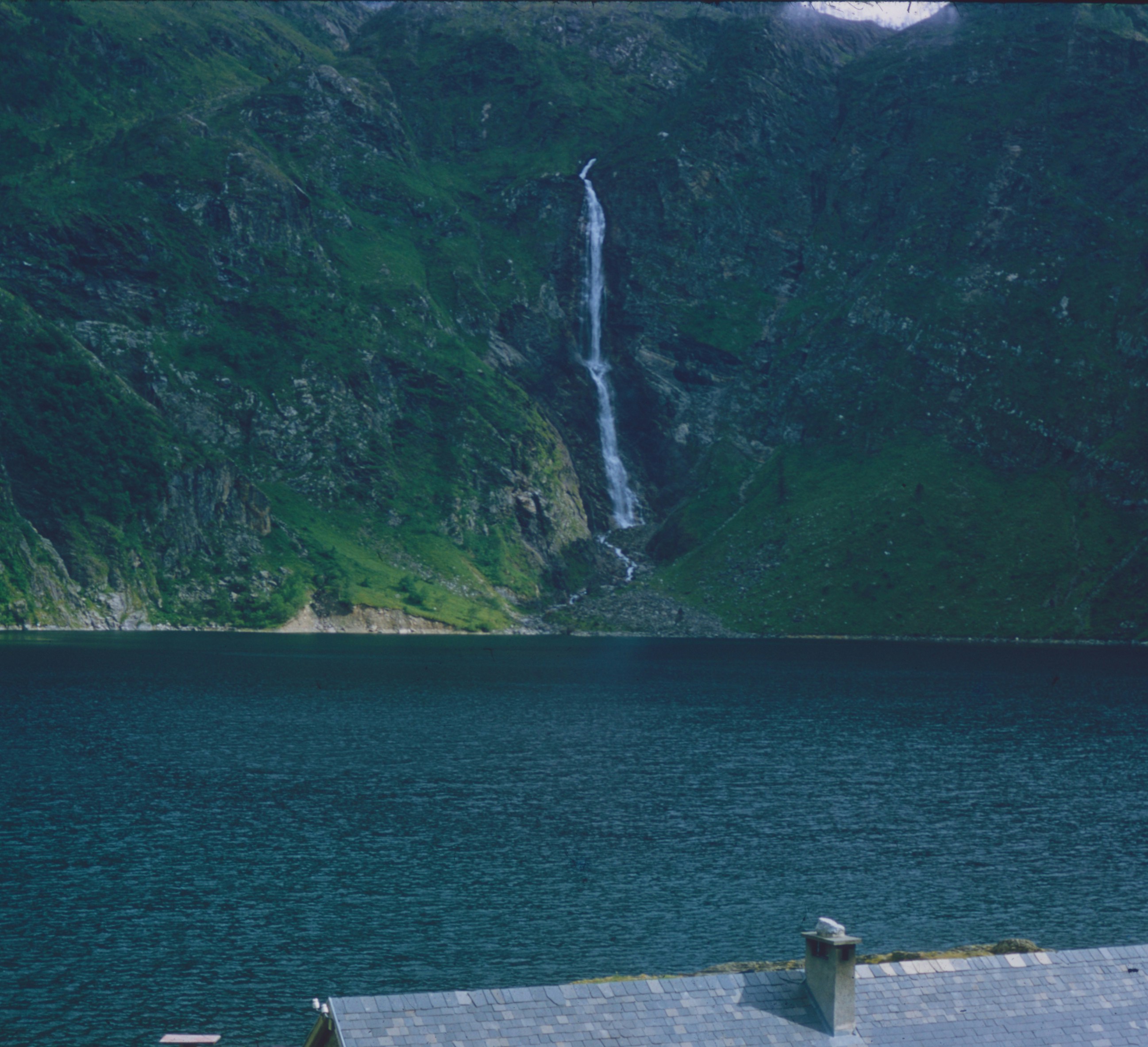 Waterfall cascading into deep blue lake - Free Photo on Unsplash