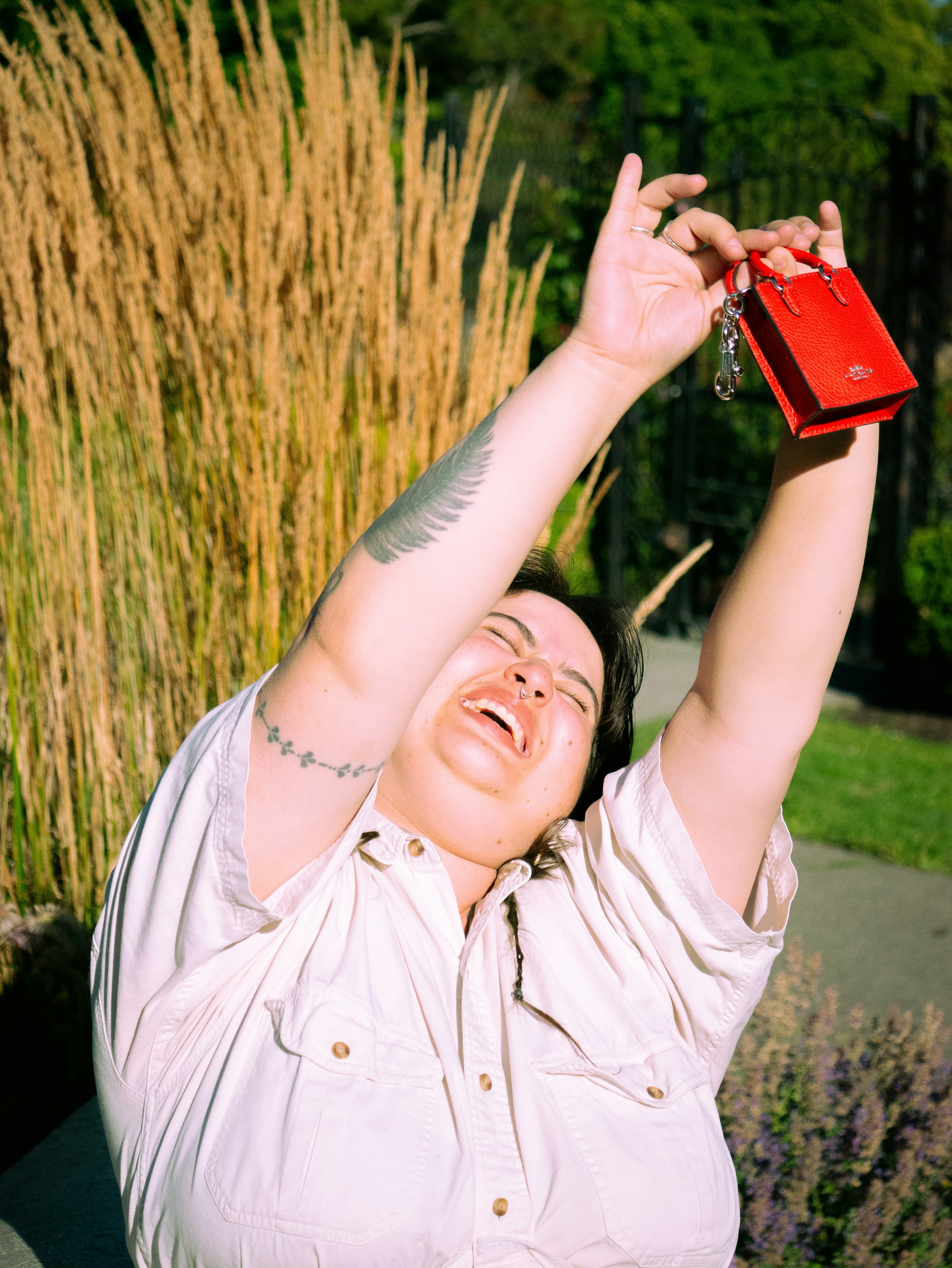 Laughing person holding small red handbag - Free Photo on Unsplash