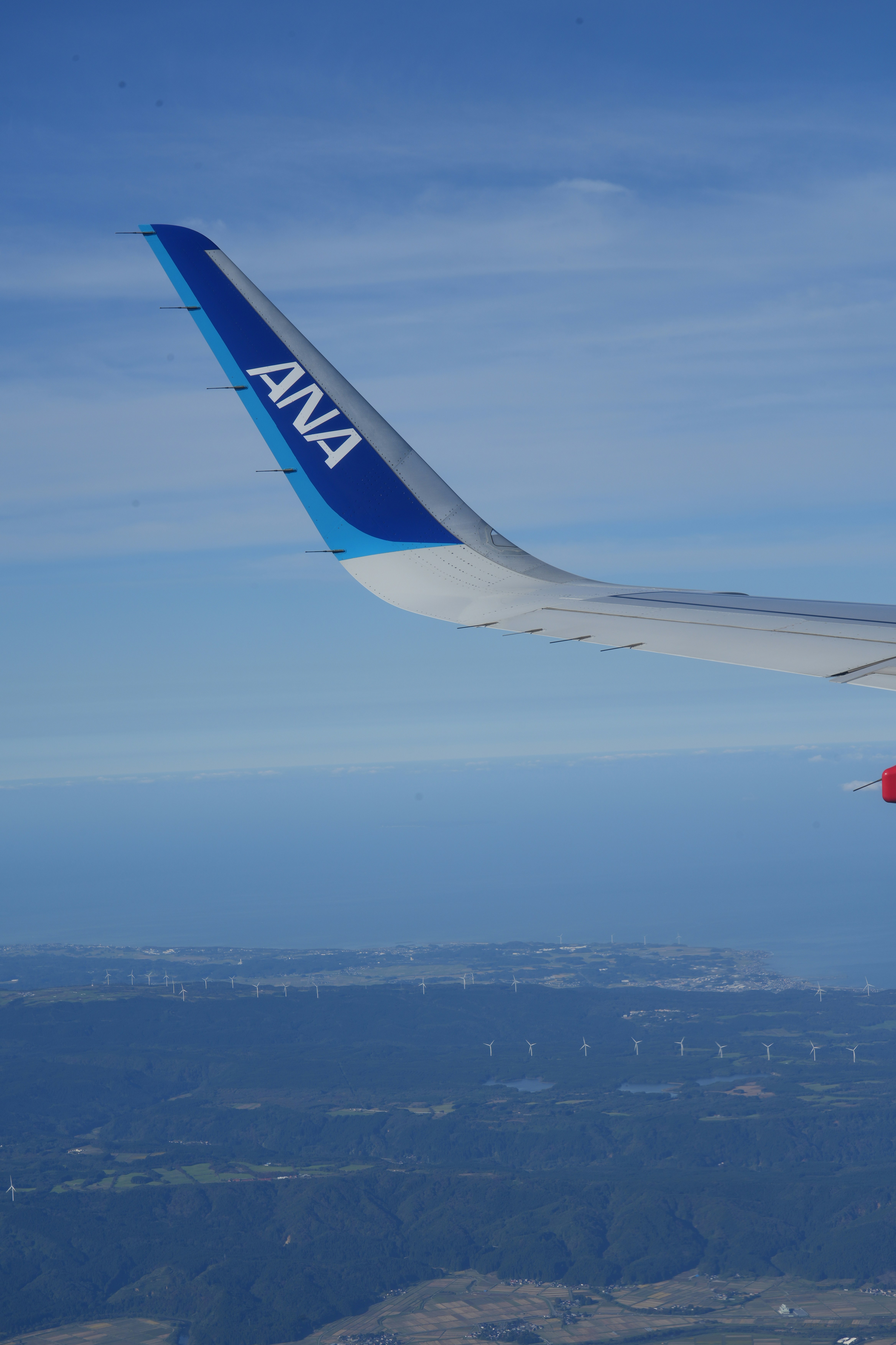 ANA airplane winglet over wind turbines - Free Photo on Unsplash