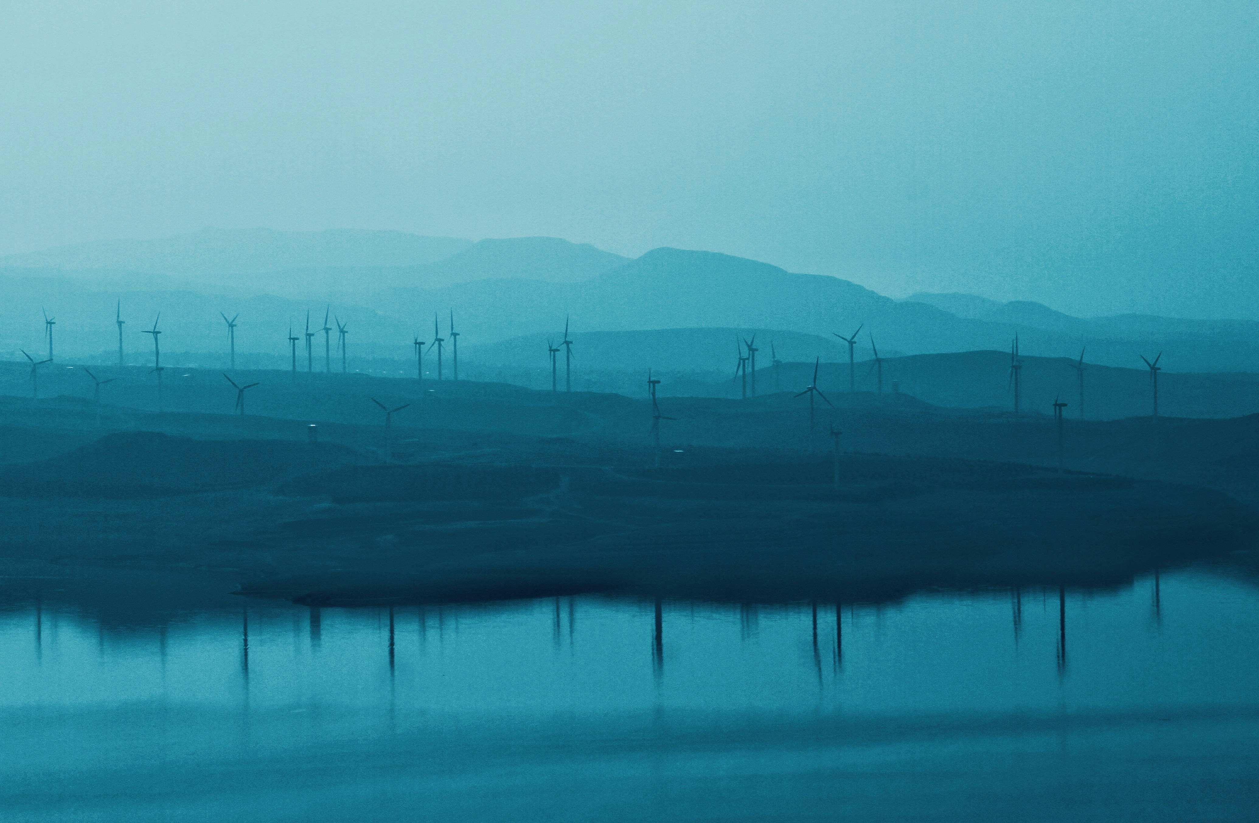 Wind turbines on blue landscape - Free Photo on Unsplash