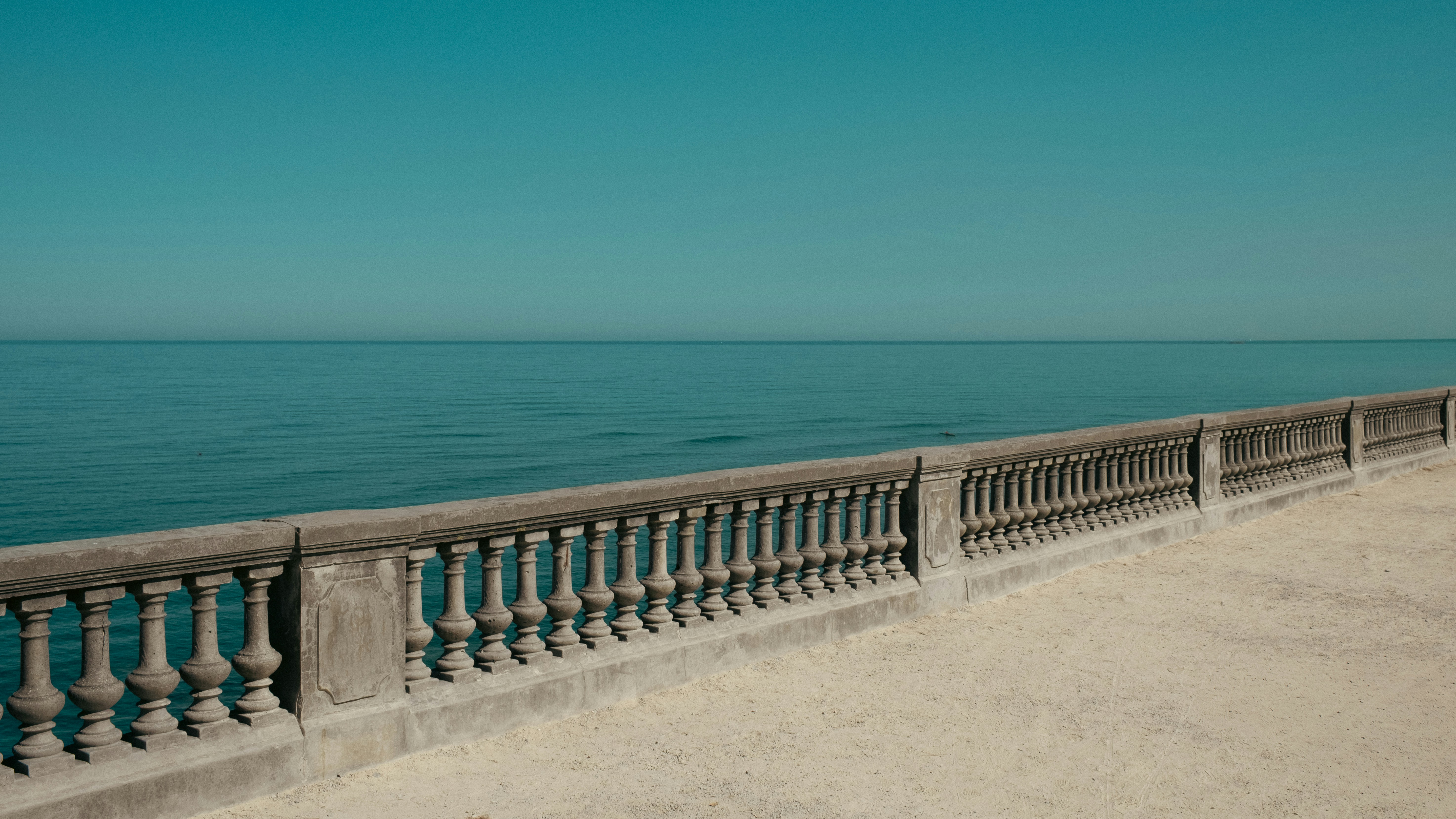 Stone balustrade overlooking calm sea - Free Photo on Unsplash