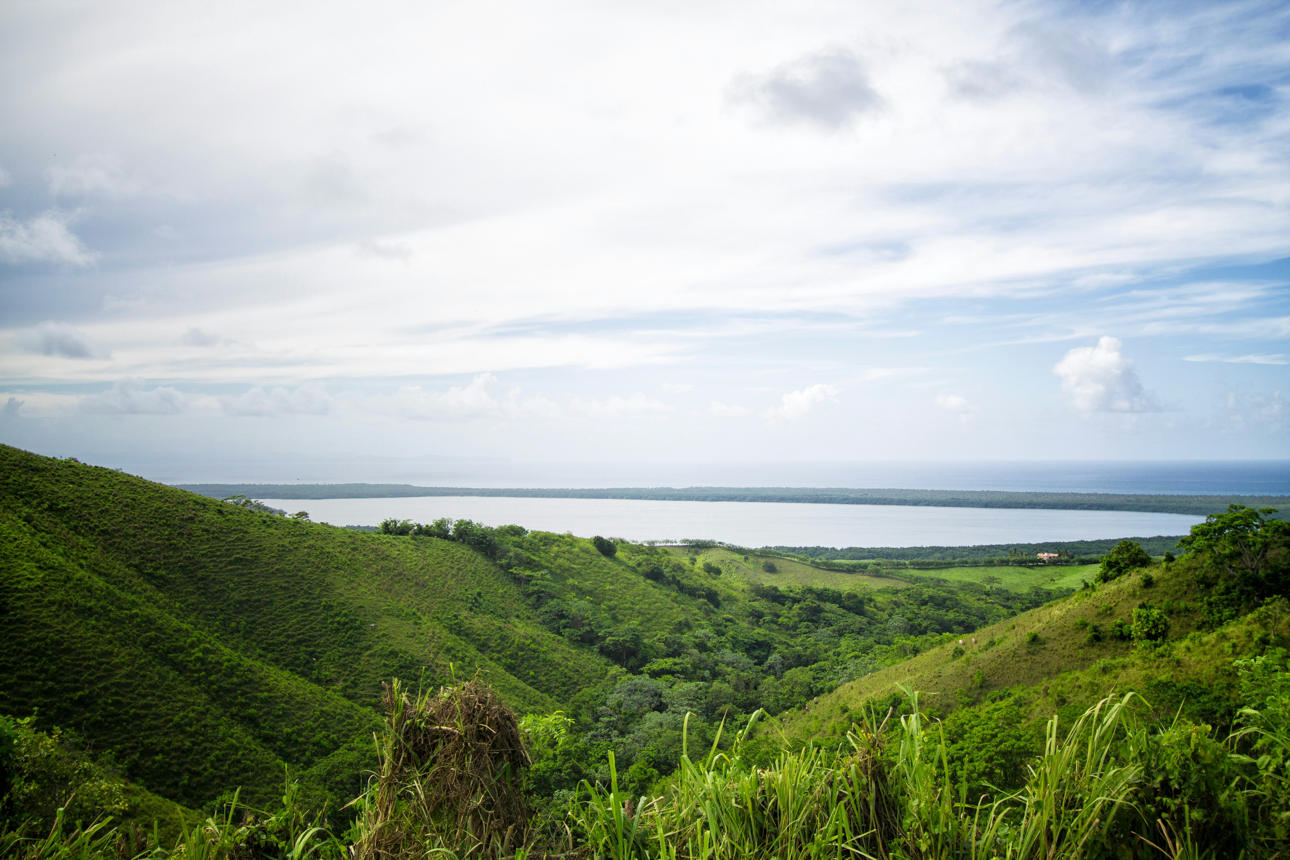 Green hills overlooking calm lake - Free Photo on Unsplash