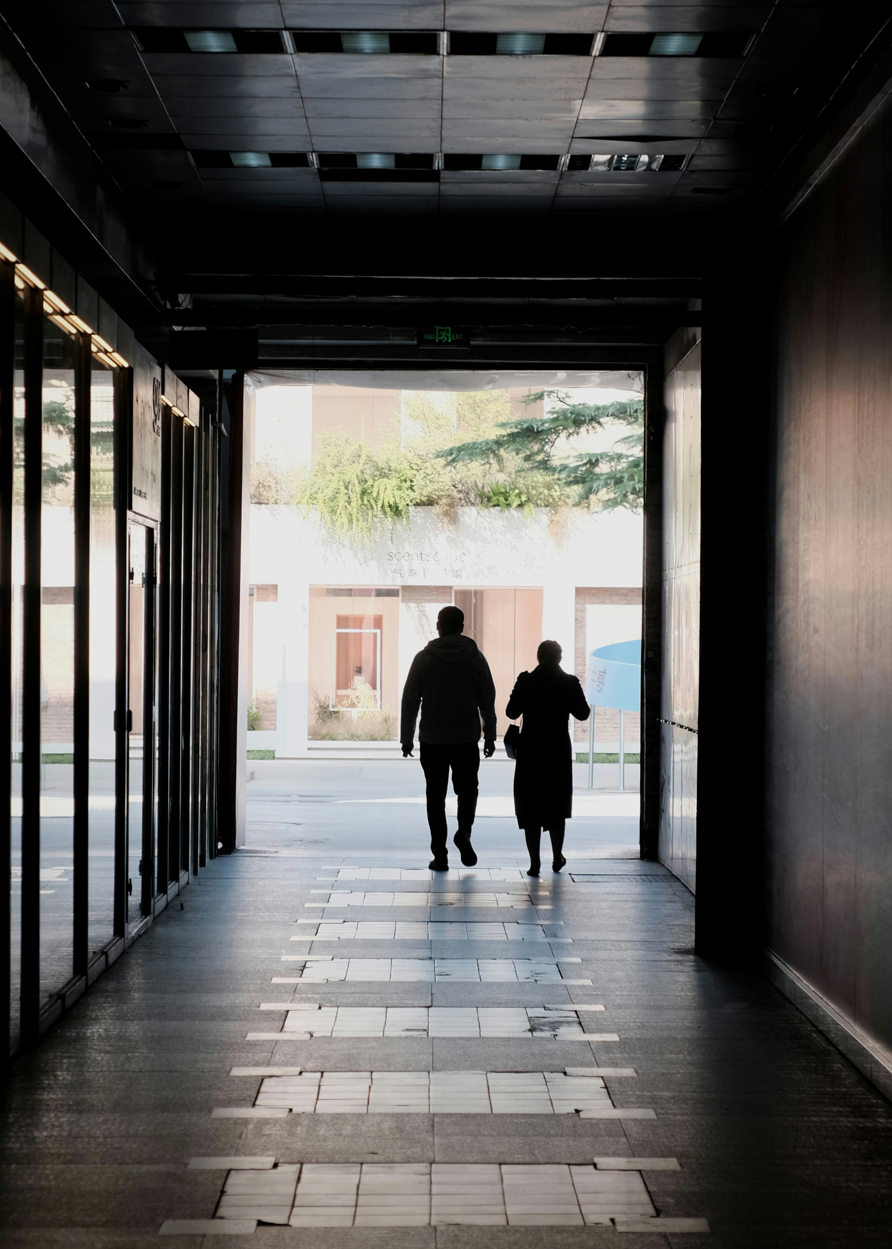 People in silhouette walking through tunnel - Free Photo on Unsplash