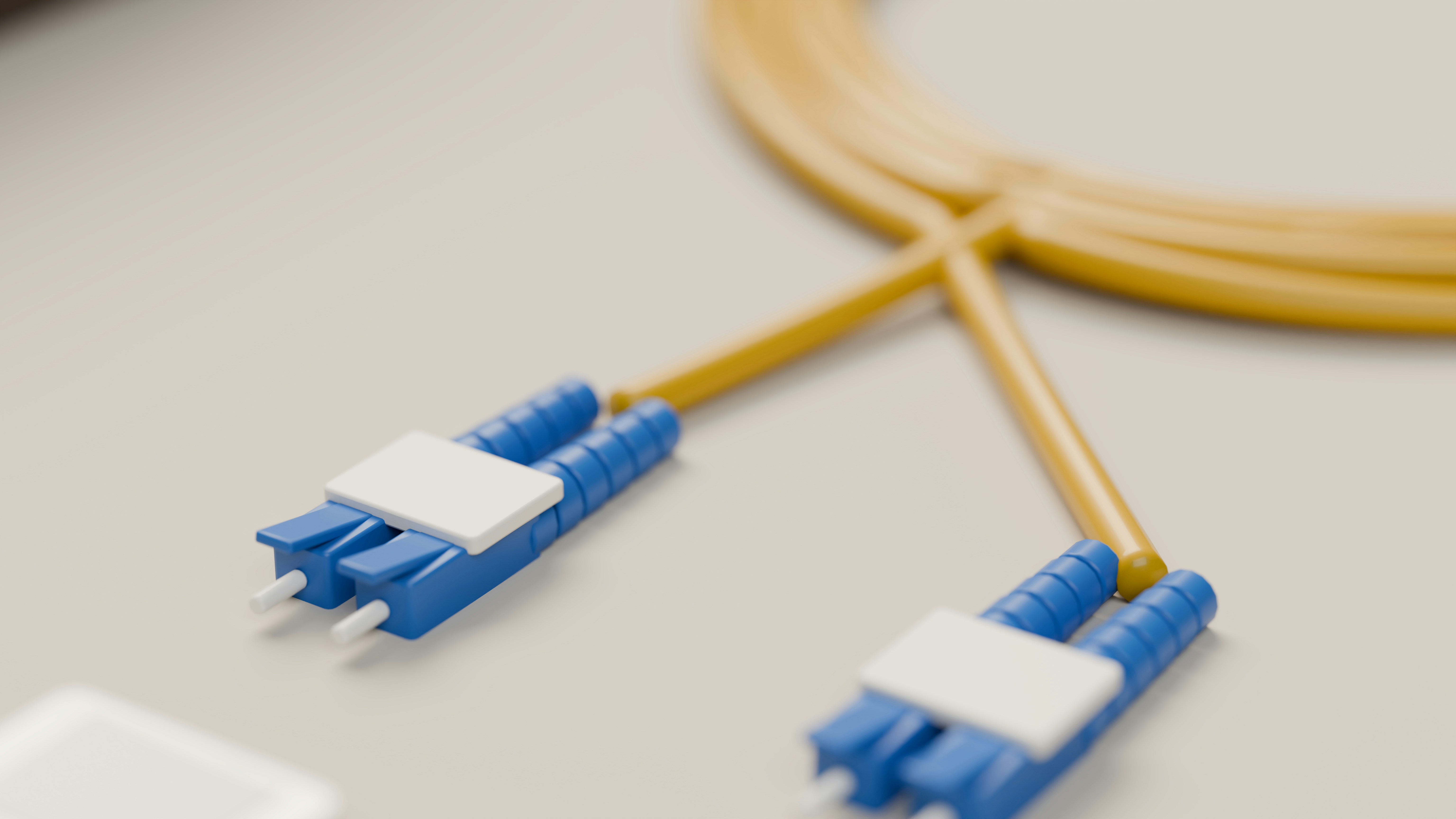 A 3D render of a yellow fiber optic cable with two blue LC duplex connectors