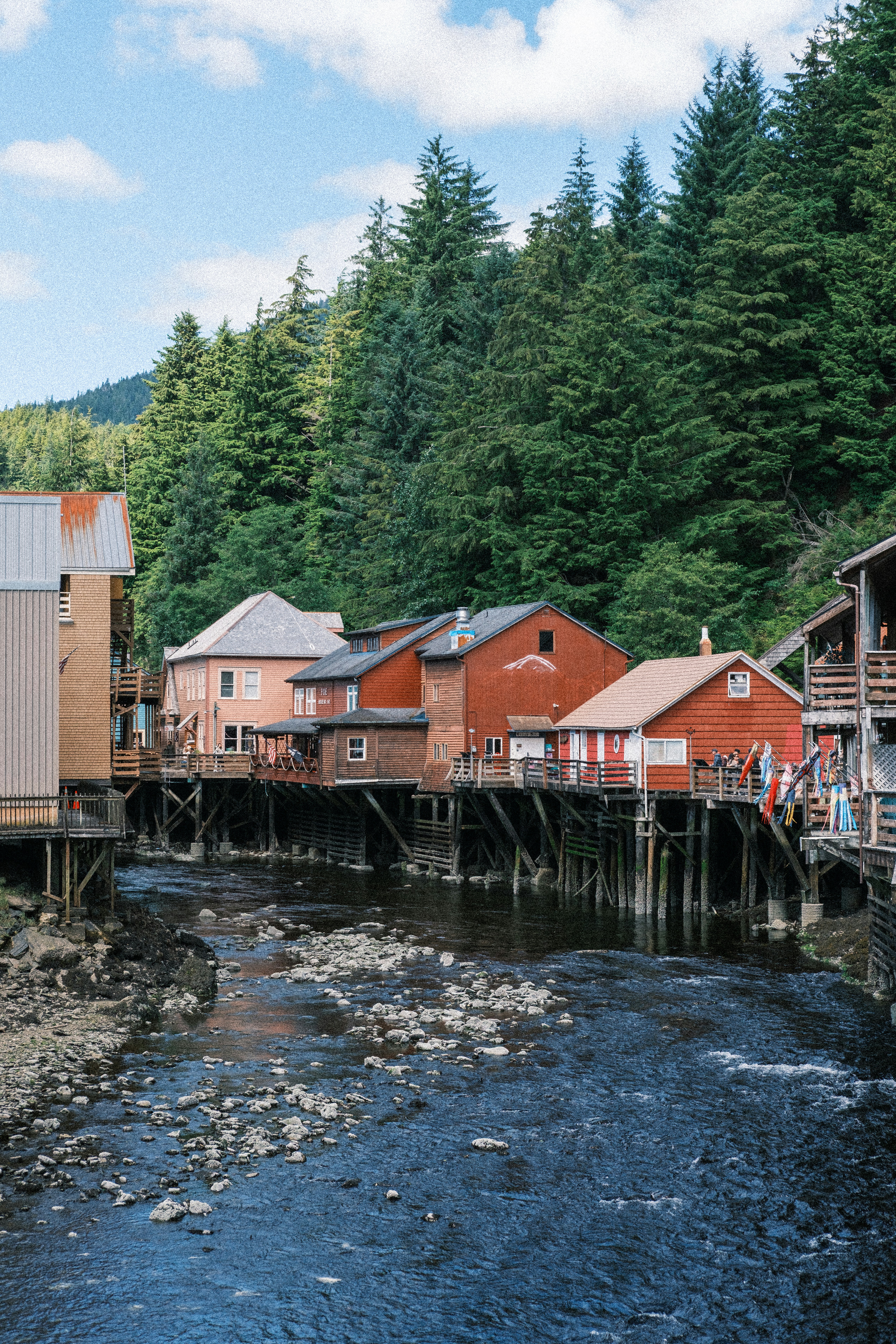 Wooden buildings on stilts over creek - Free Photo on Unsplash