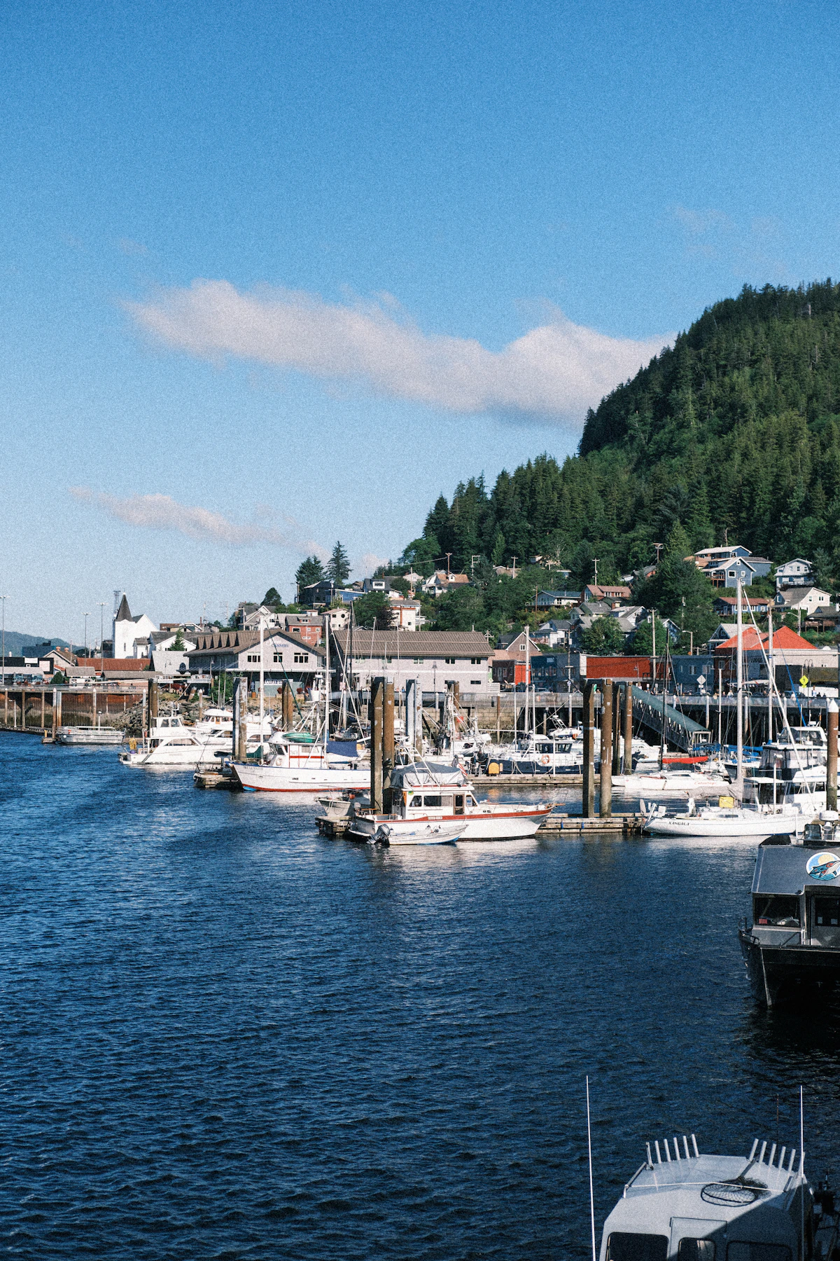 Fishing boats moored at a dock in a coastal town
