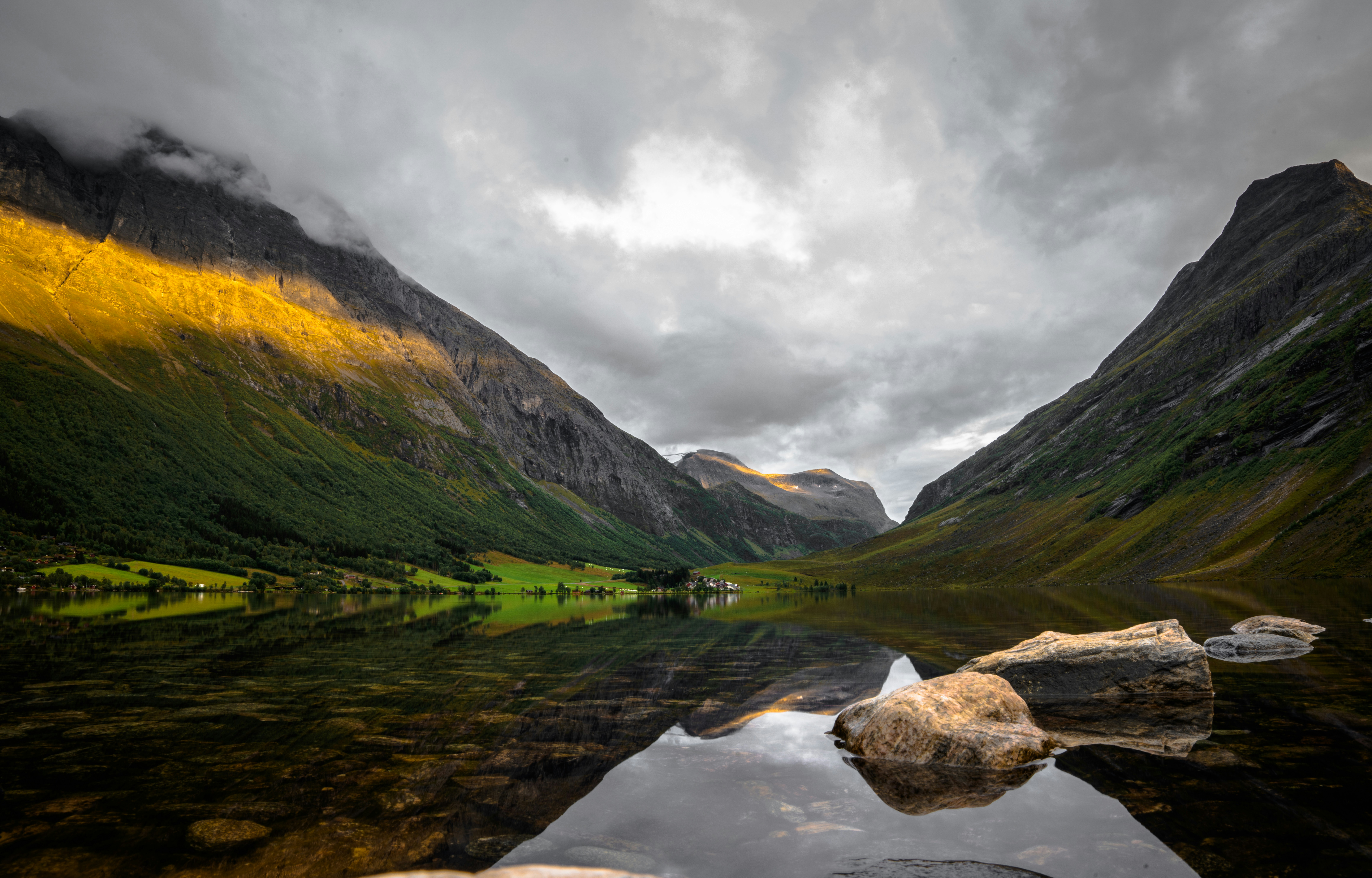 Calm lake reflecting steep mountain slopes - Free Photo on Unsplash