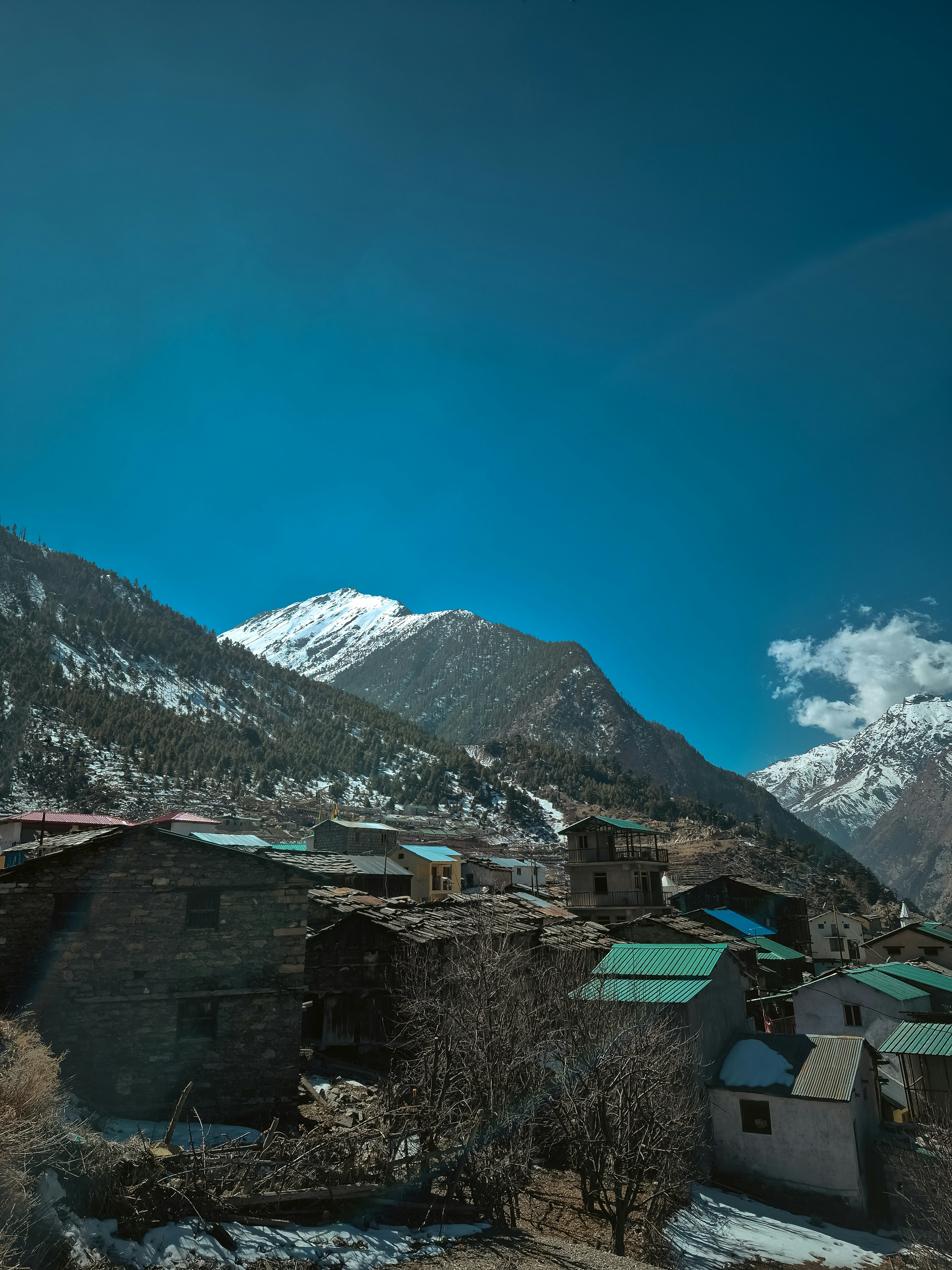 Mountain village with snow-capped peaks - Free Photo on Unsplash