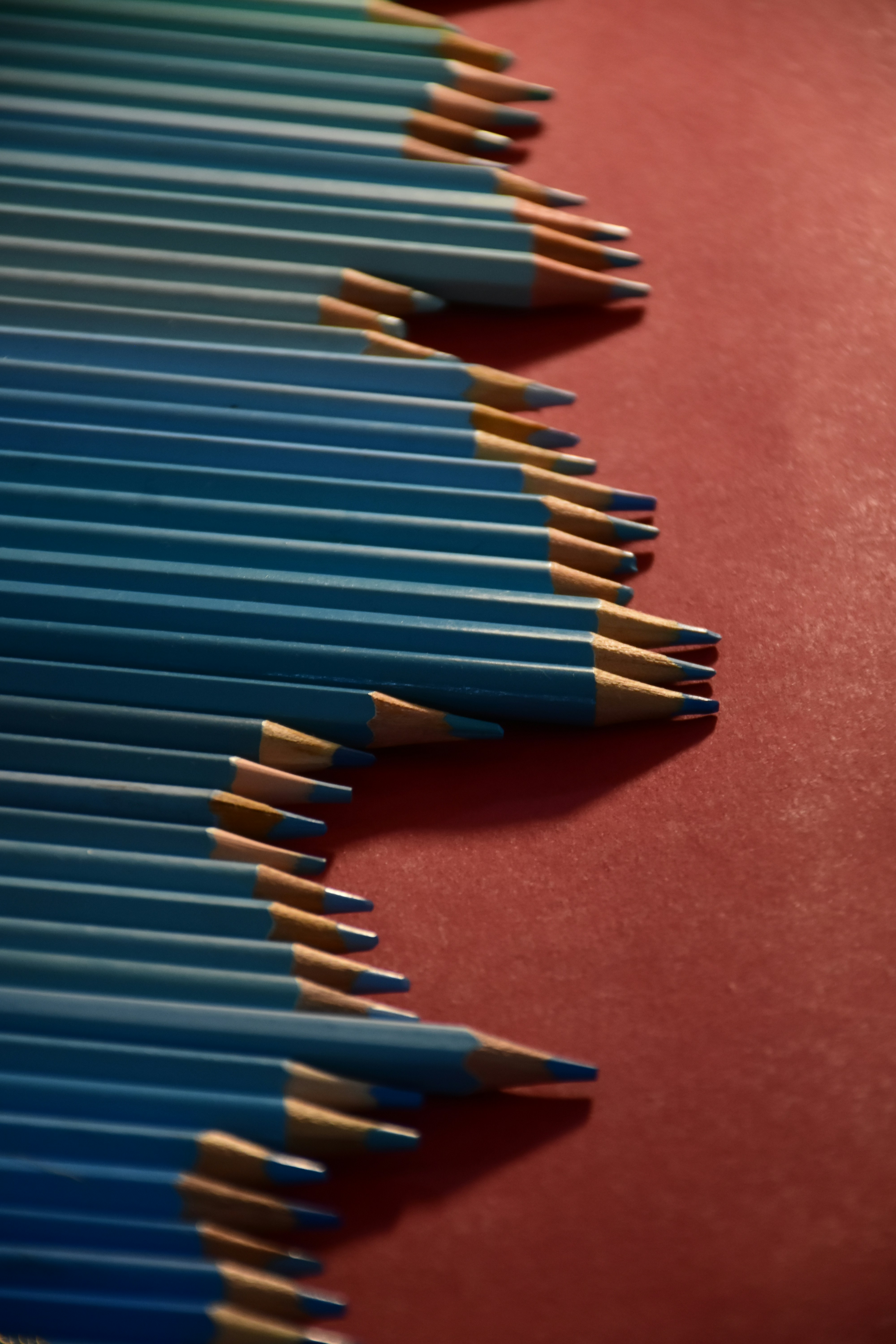 Light blue pencils on red surface - Free Photo on Unsplash