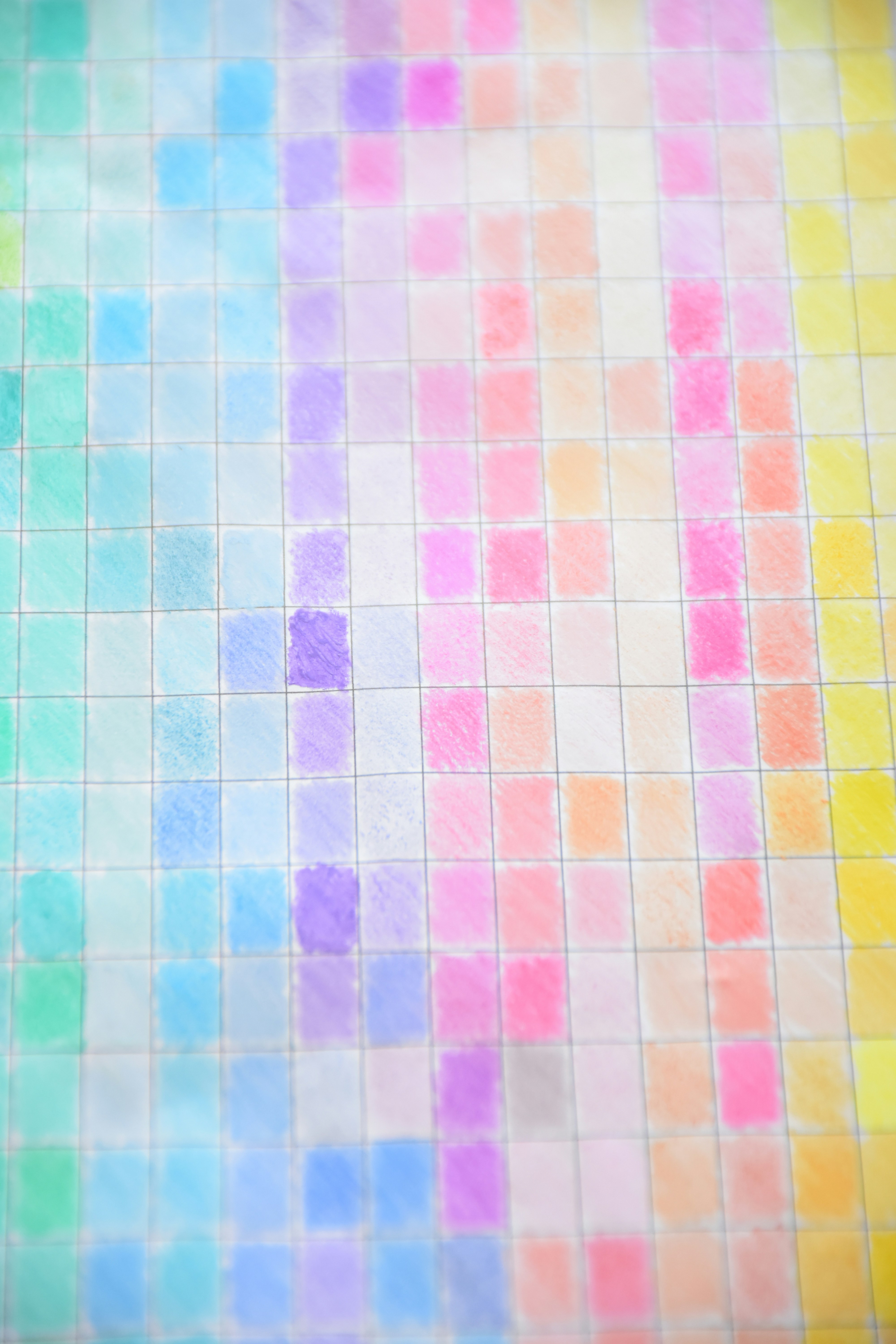 A grid of hand-drawn pastel colored squares on white paper