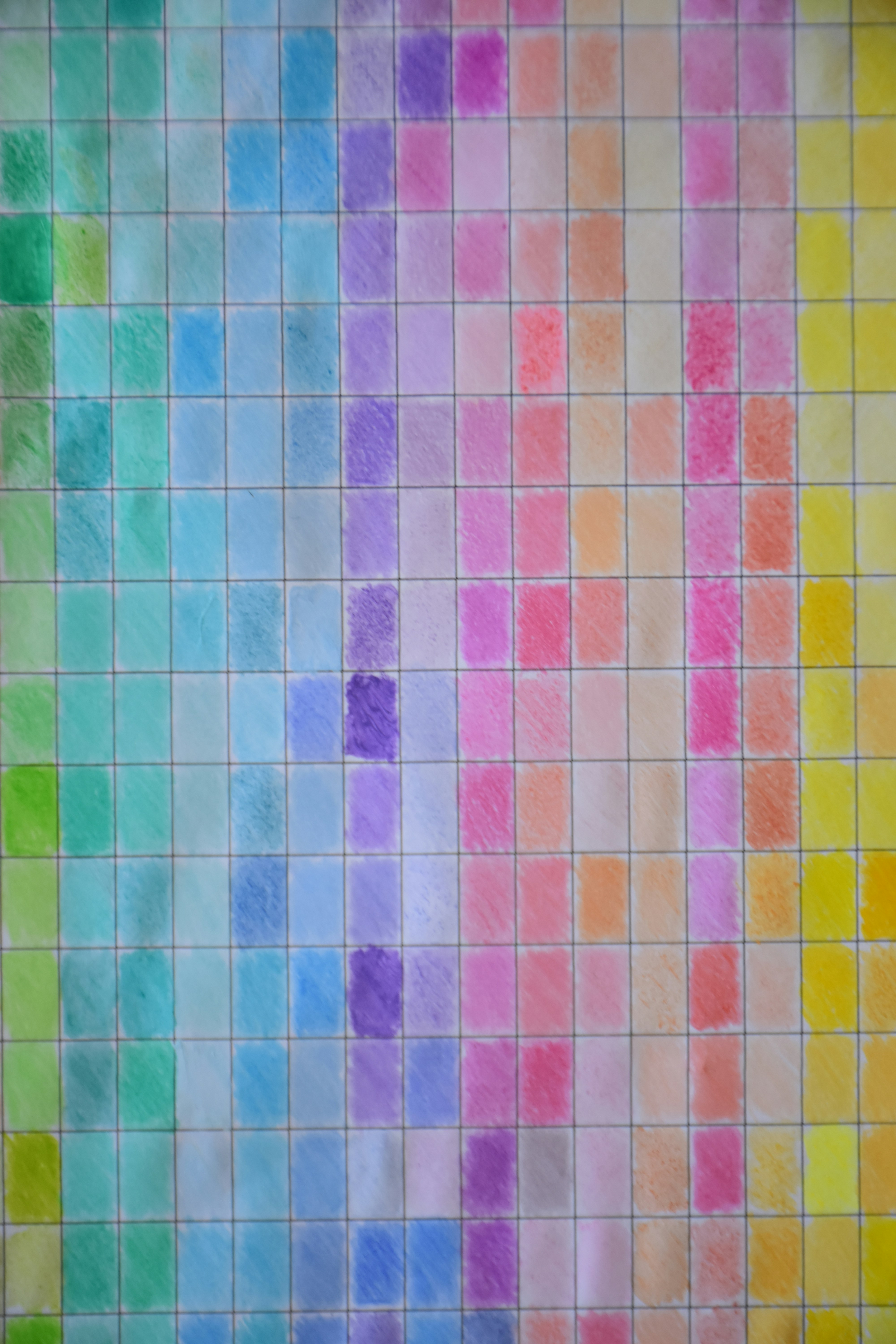 A grid of hand-drawn colored pencil squares in a spectrum of rainbow hues