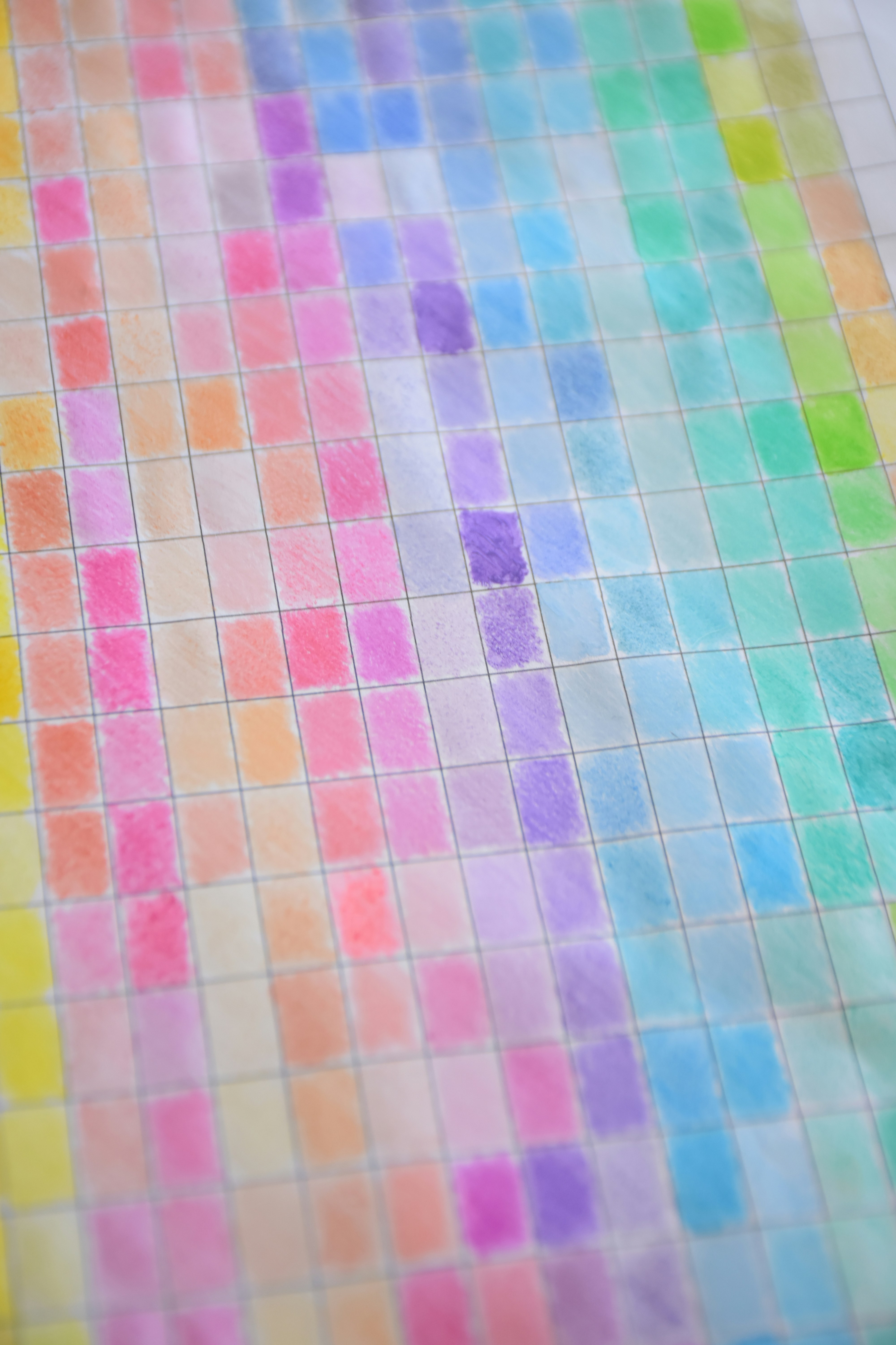 A grid of hand-drawn colored pencil swatches in a spectrum of pastel and vibrant hues