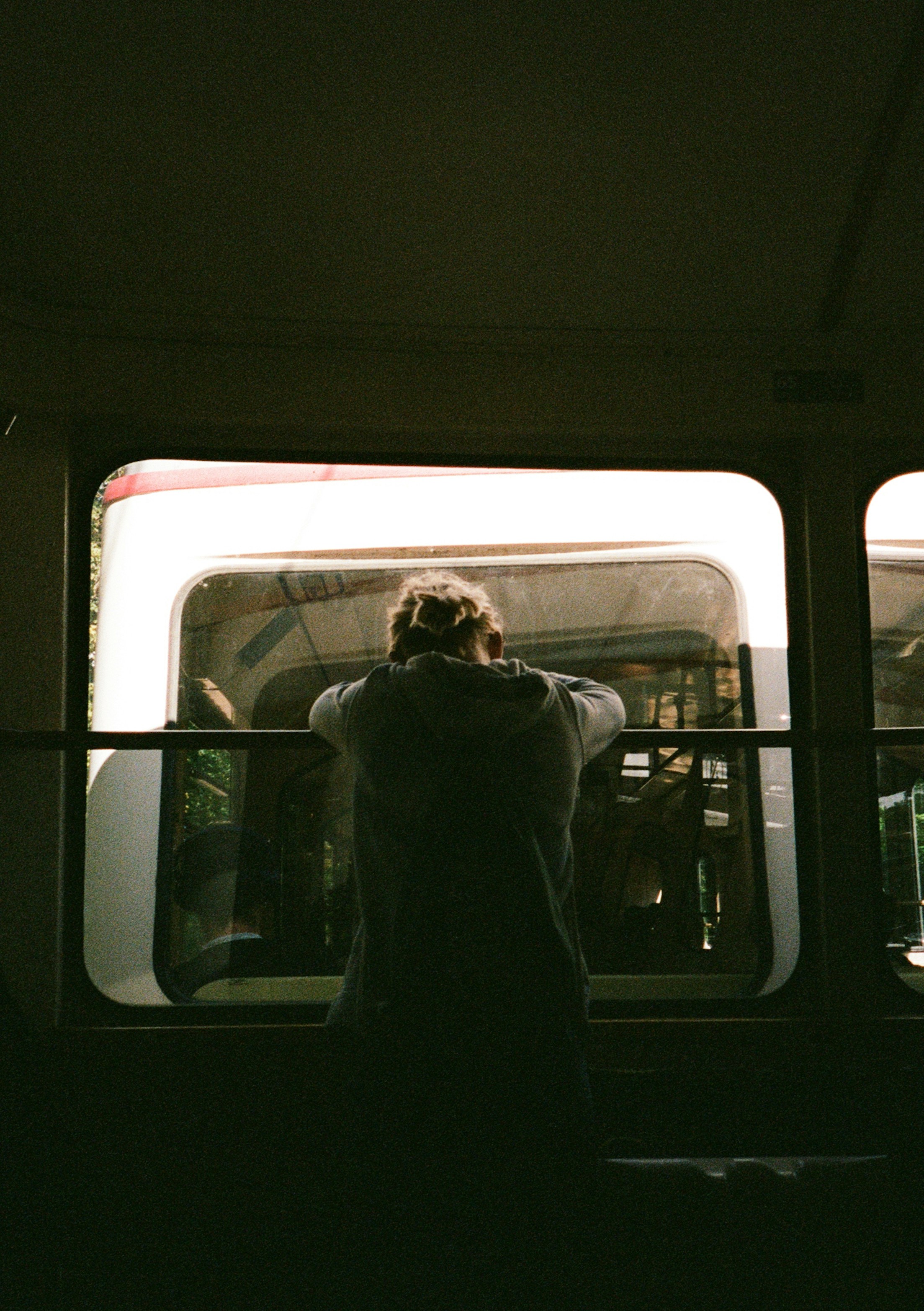 A person in a hoodie leaning against a window on a tram in Budapest - 相关推荐
