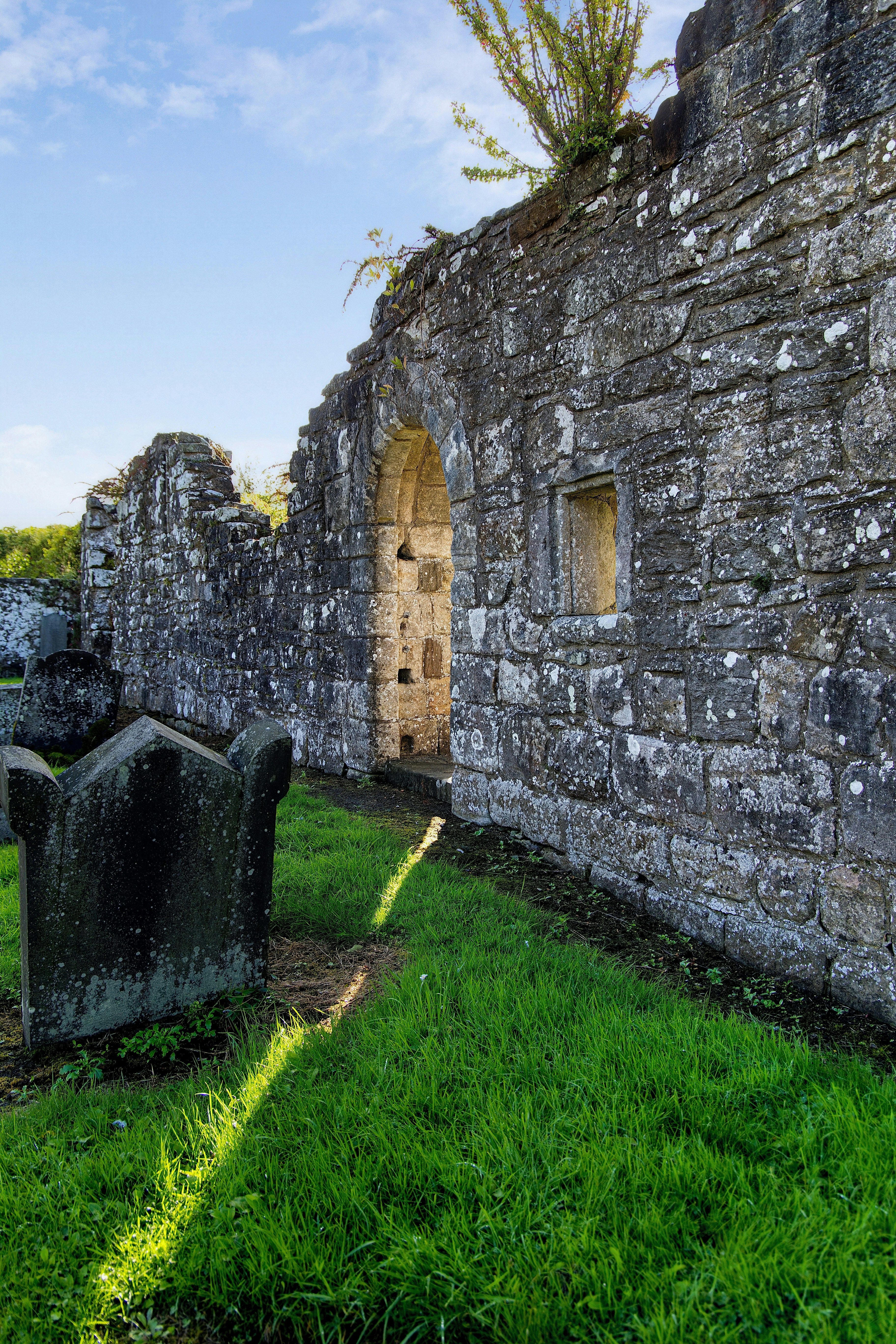 Ancient stone wall in grassy cemetery - Free Photo on Unsplash