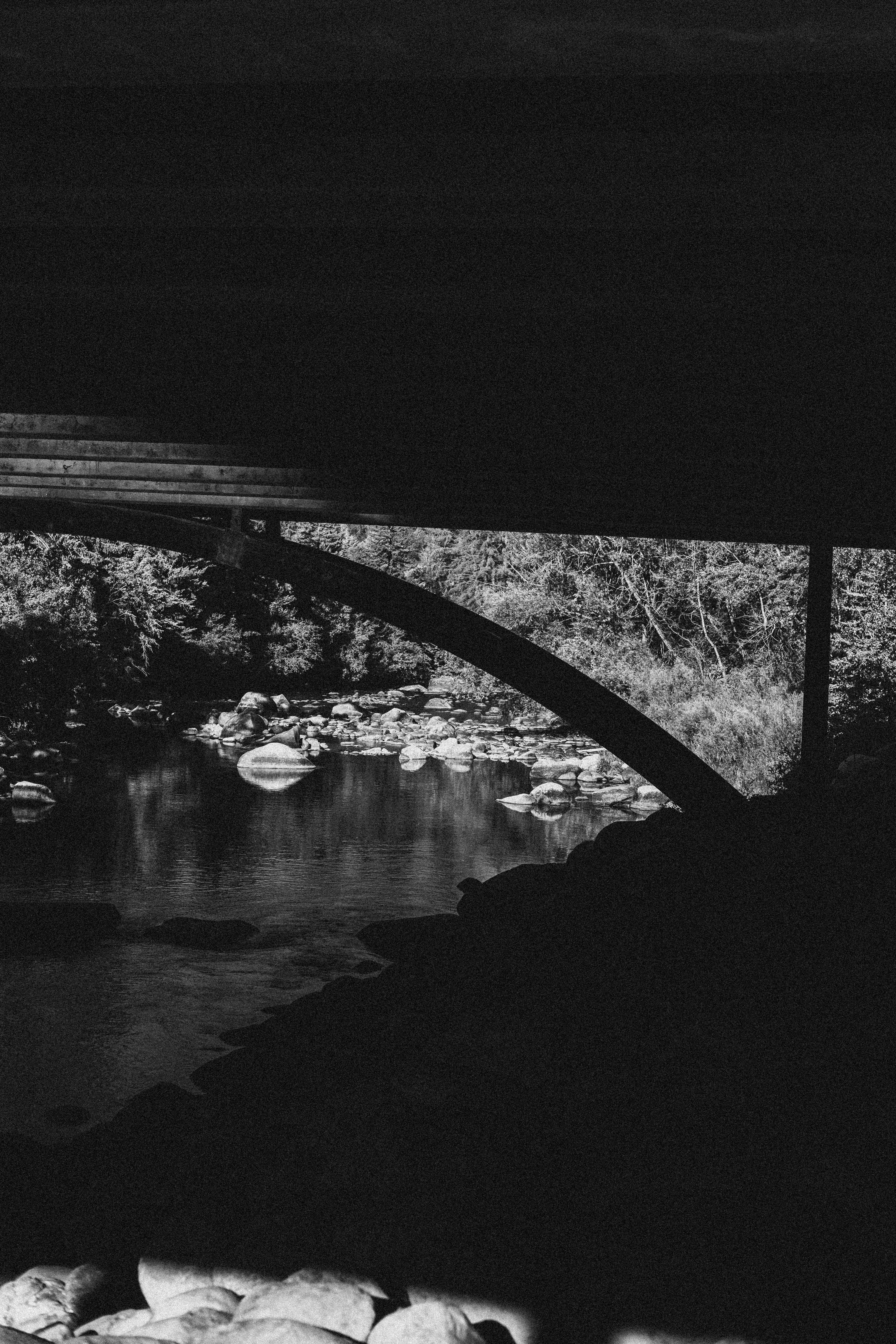 Rocky river under bridge arch - Free Photo on Unsplash
