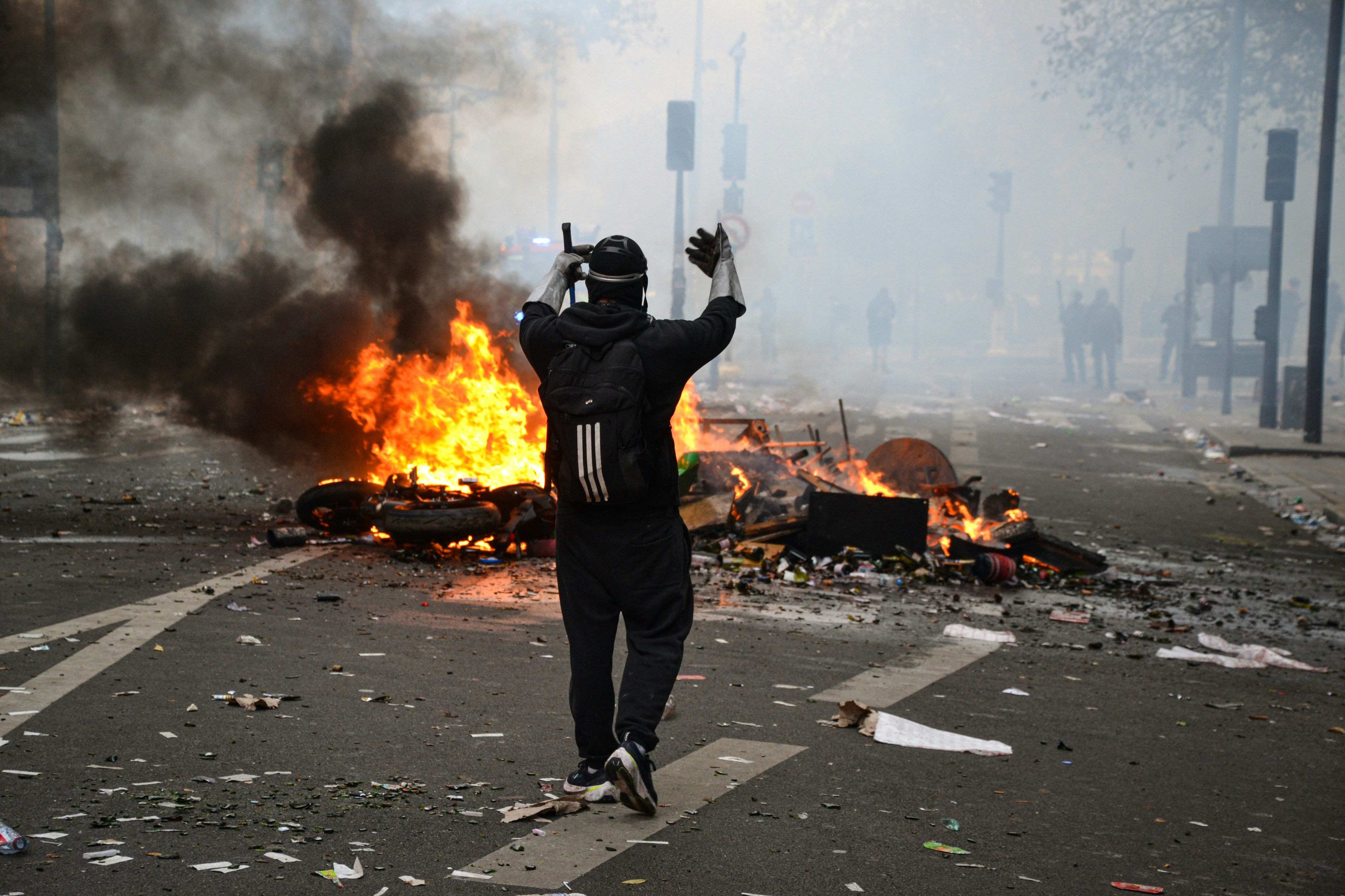 Person standing before burning street barricade - Free Photo on Unsplash