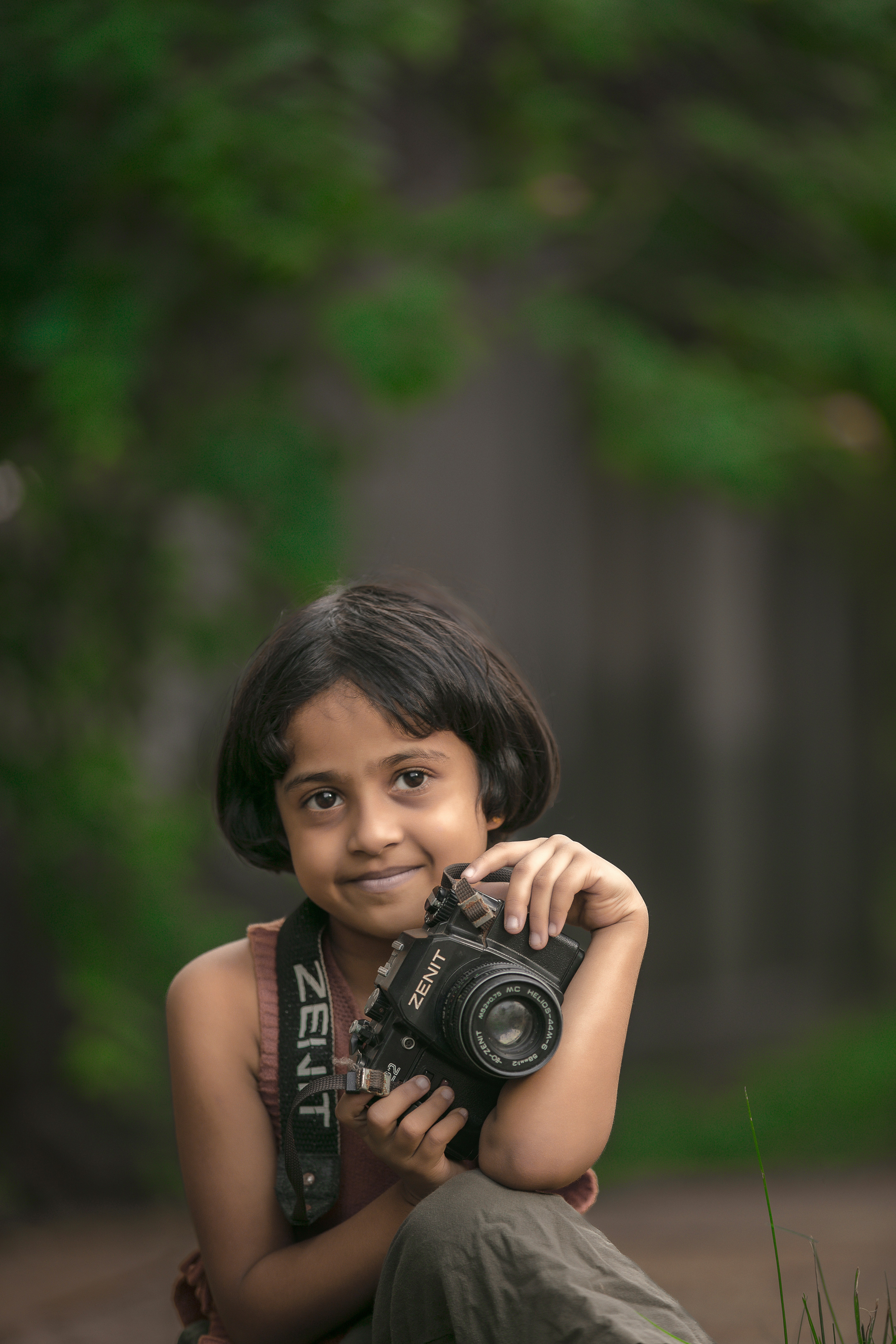 Child holding vintage Zenit camera - Free Photo on Unsplash