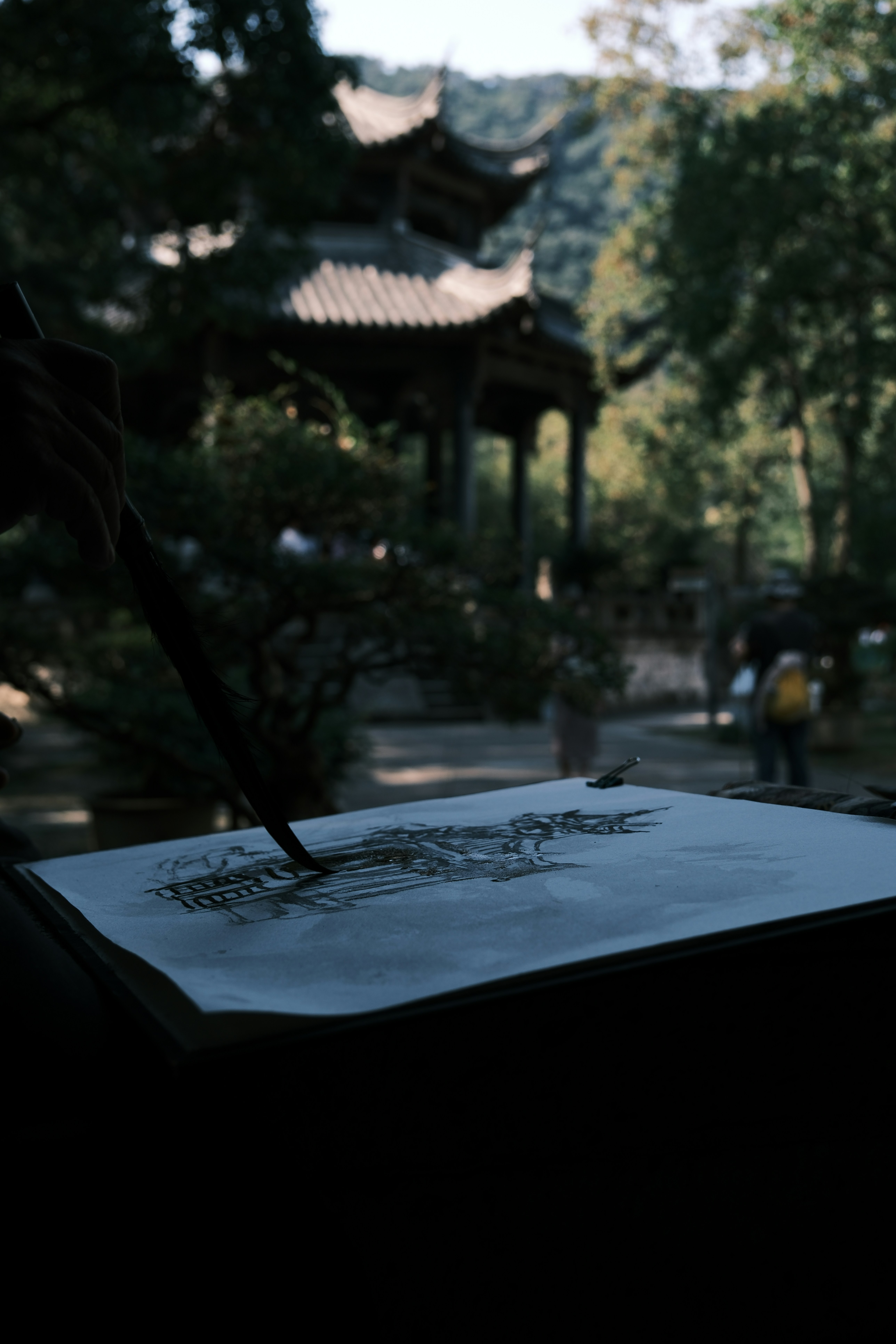 Person painting traditional pavilion on paper - Free Photo on Unsplash