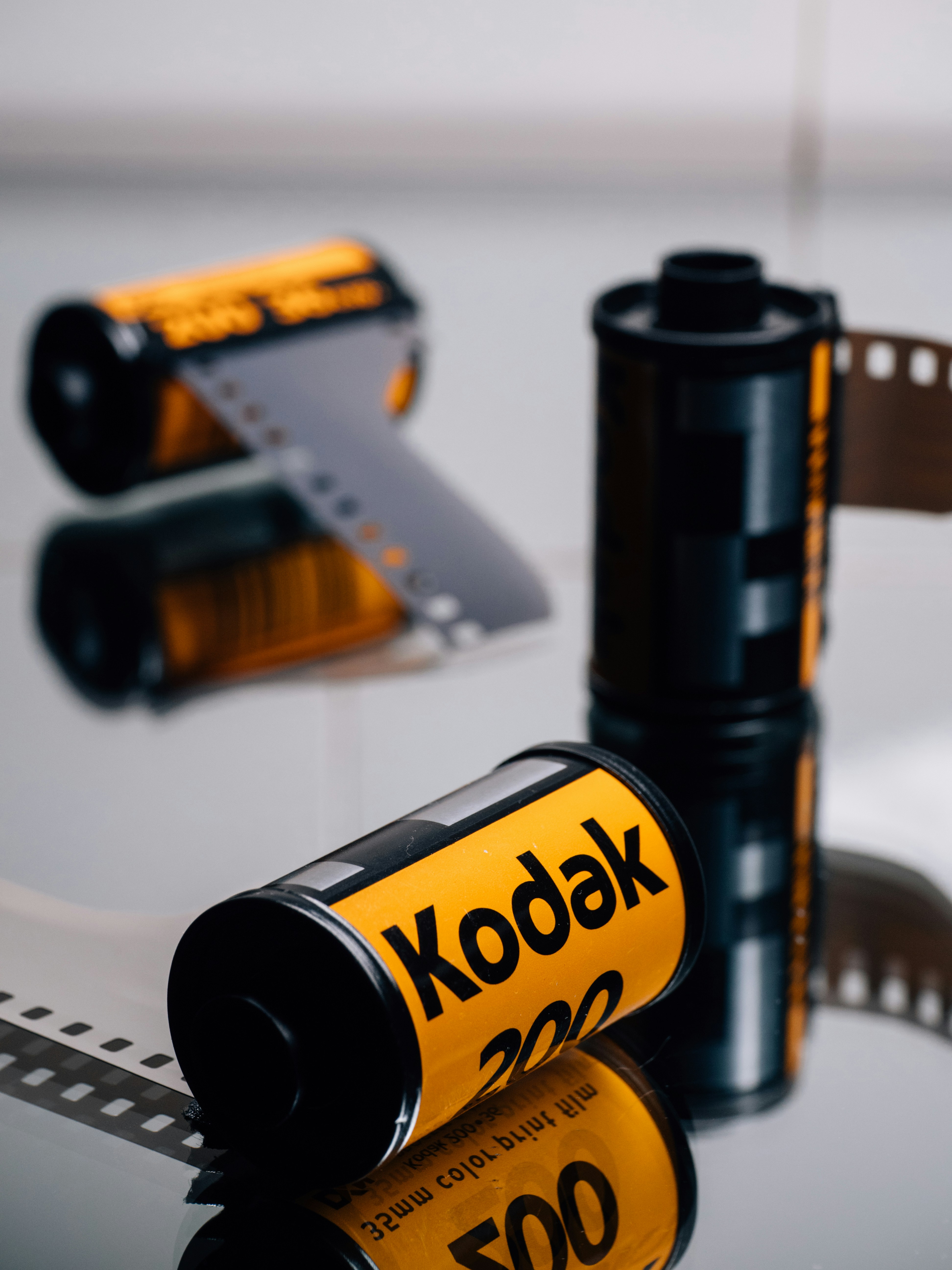 Film rolls on reflective surface - Free Photo on Unsplash