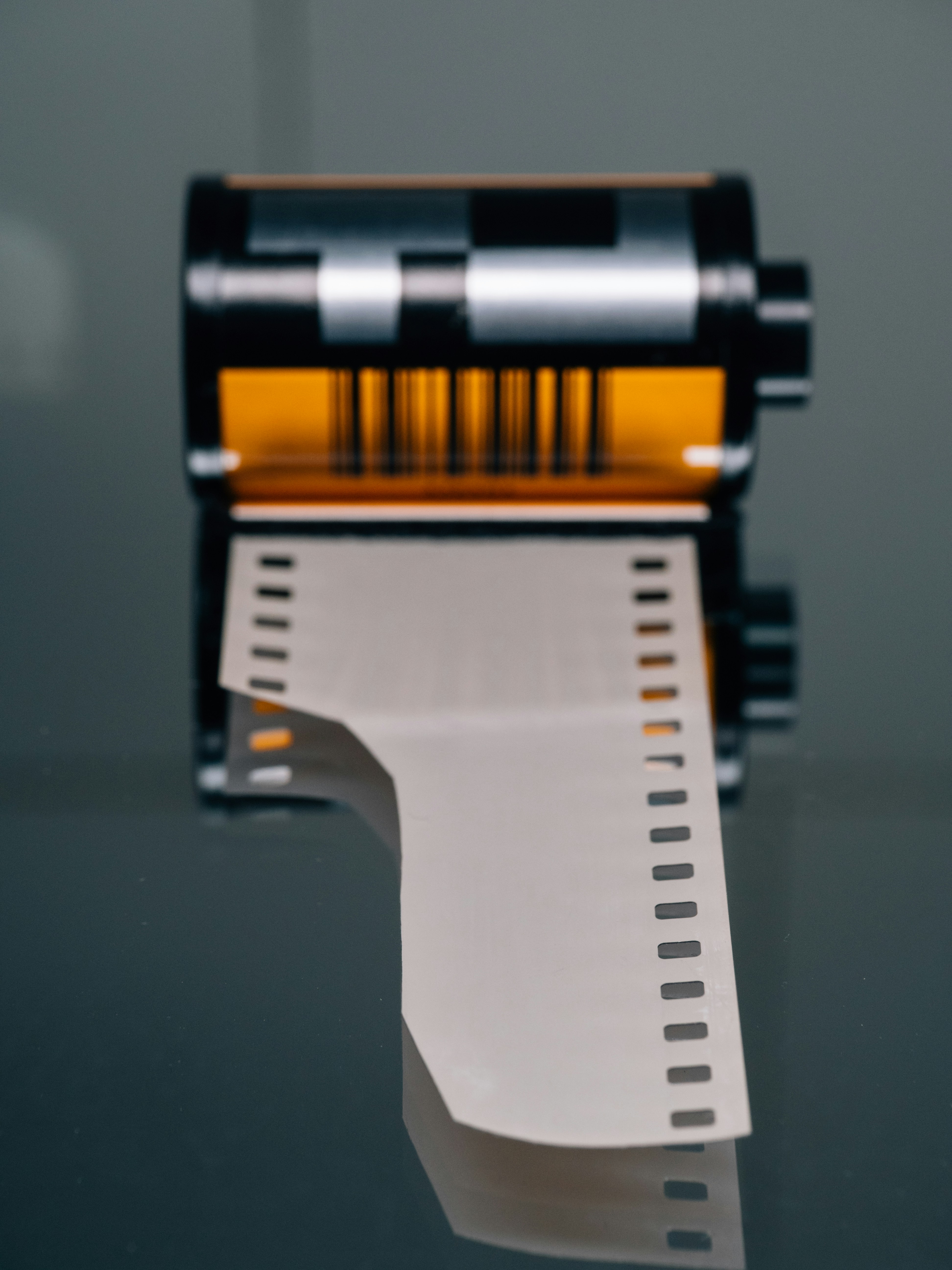 35mm film roll on reflective surface - Free Photo on Unsplash