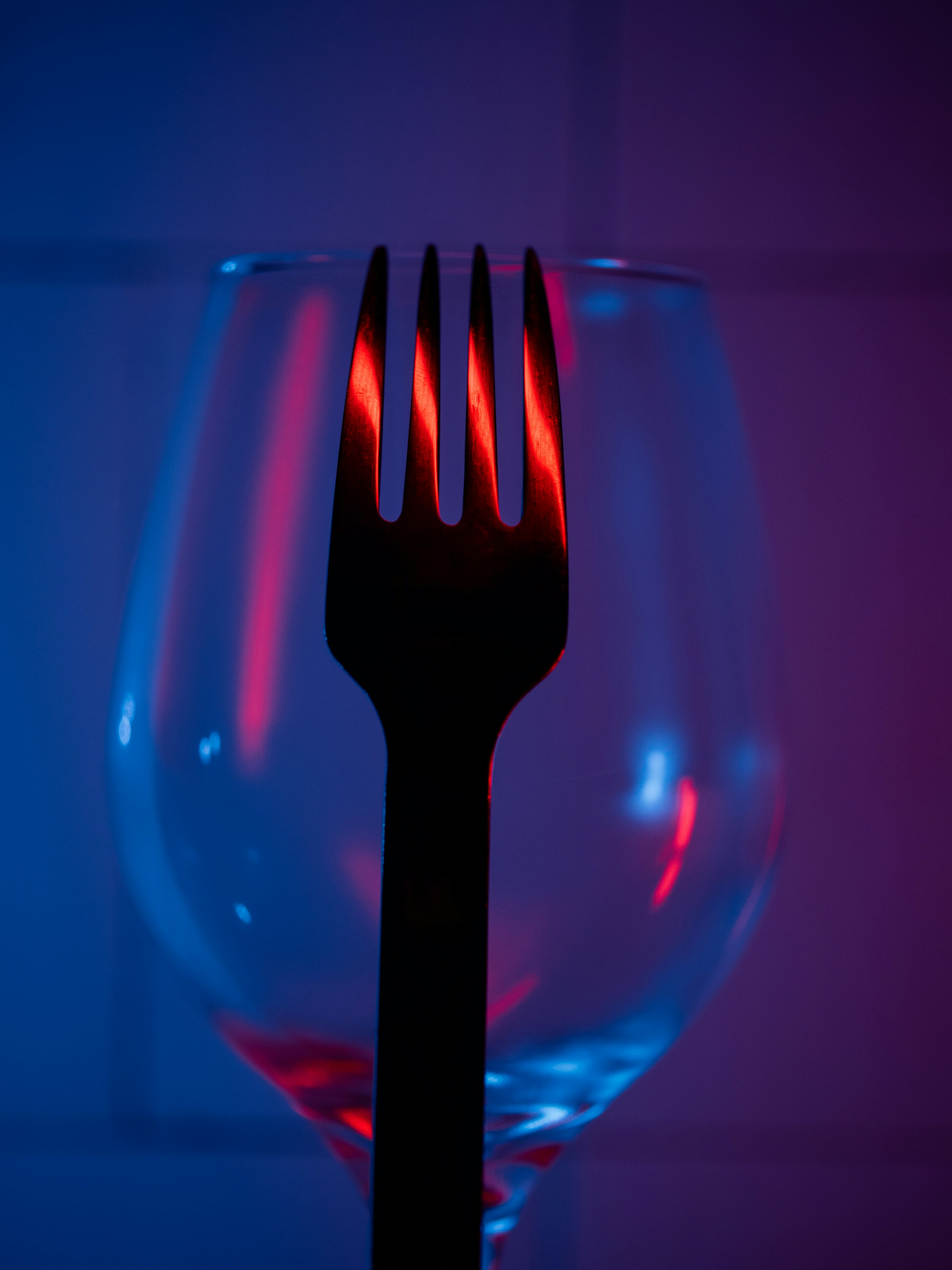 Fork silhouetted against wine glass - Free Photo on Unsplash
