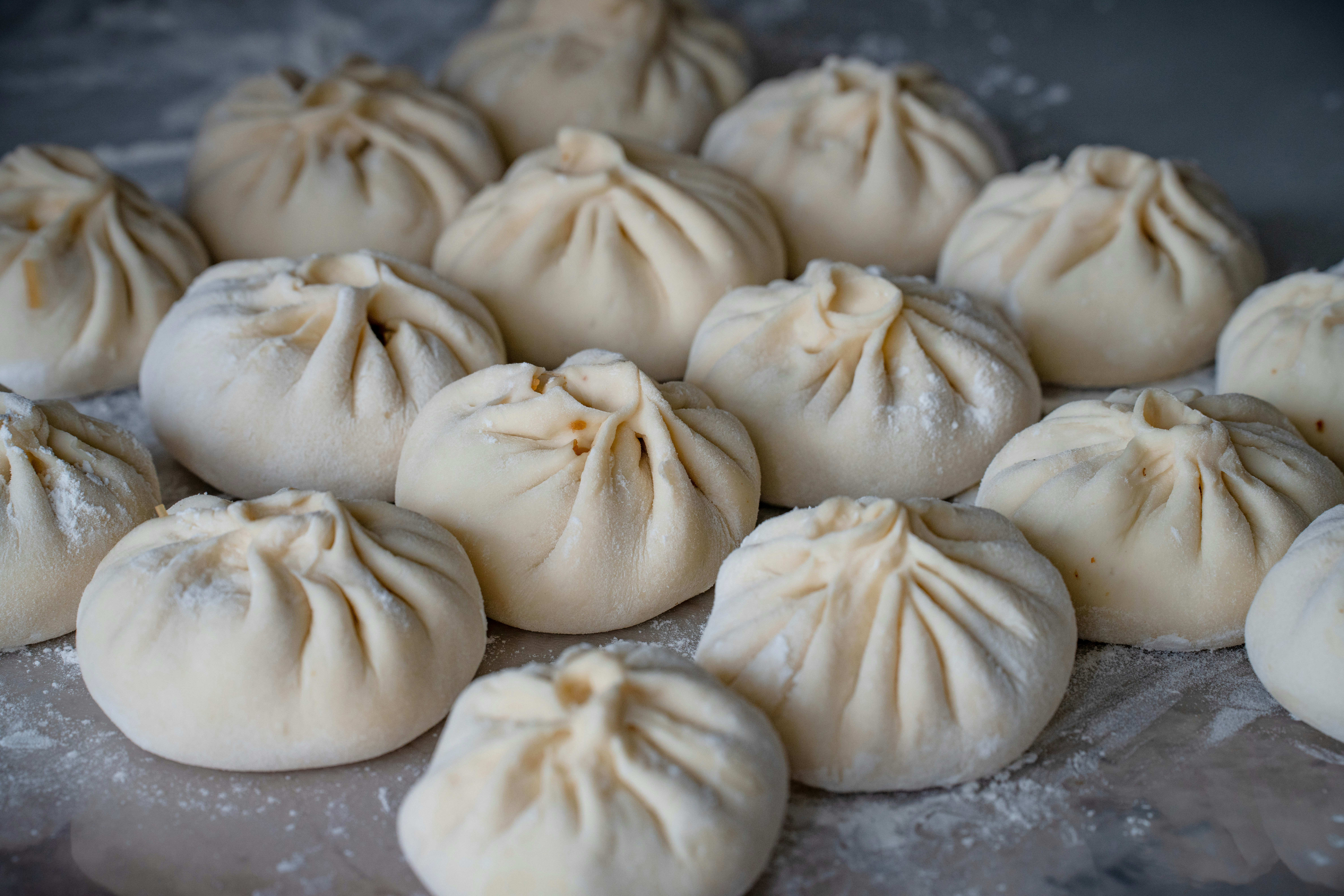 Raw pleated dumplings on floured surface - Free Photo on Unsplash
