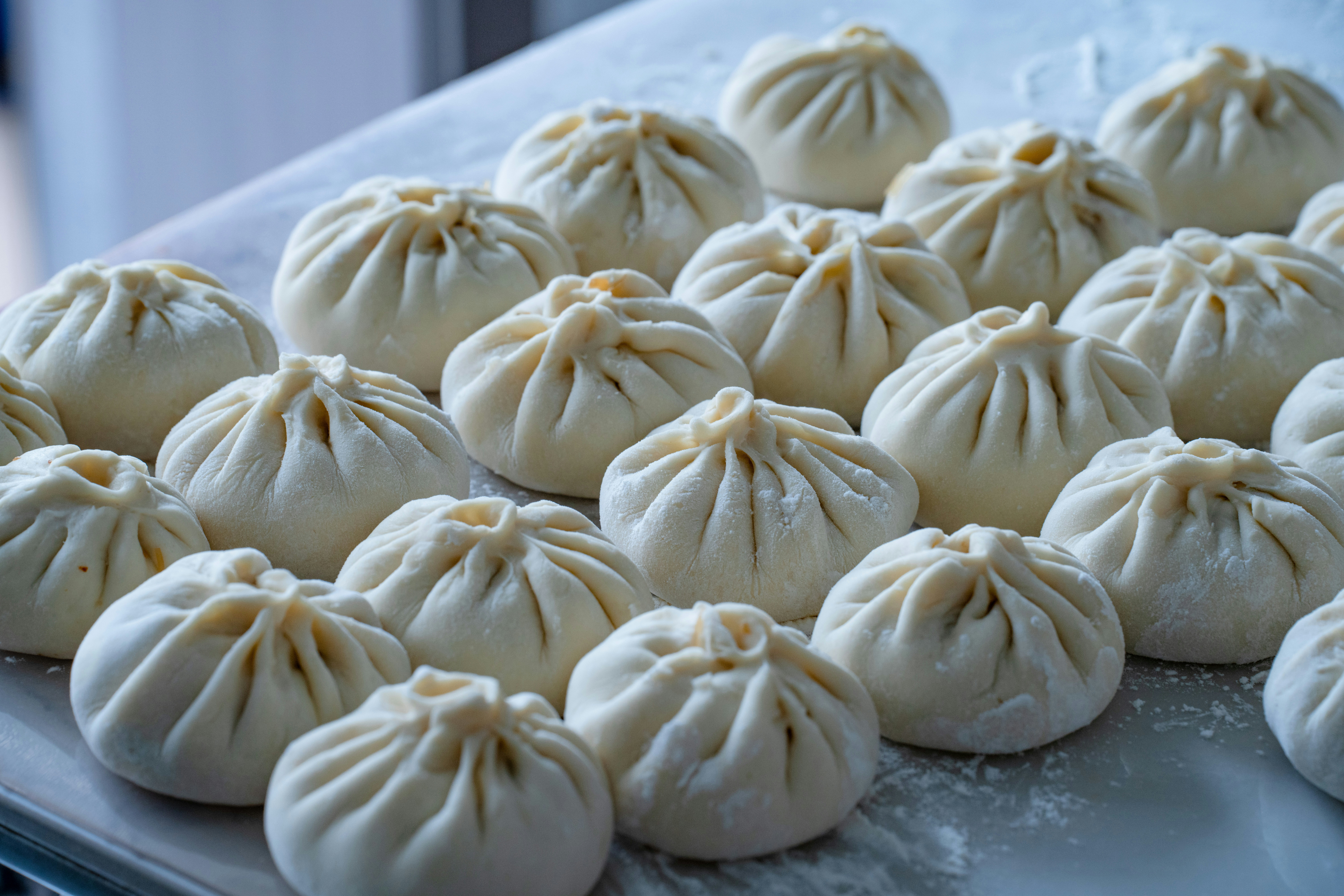 Raw steamed buns on floured surface - Free Photo on Unsplash