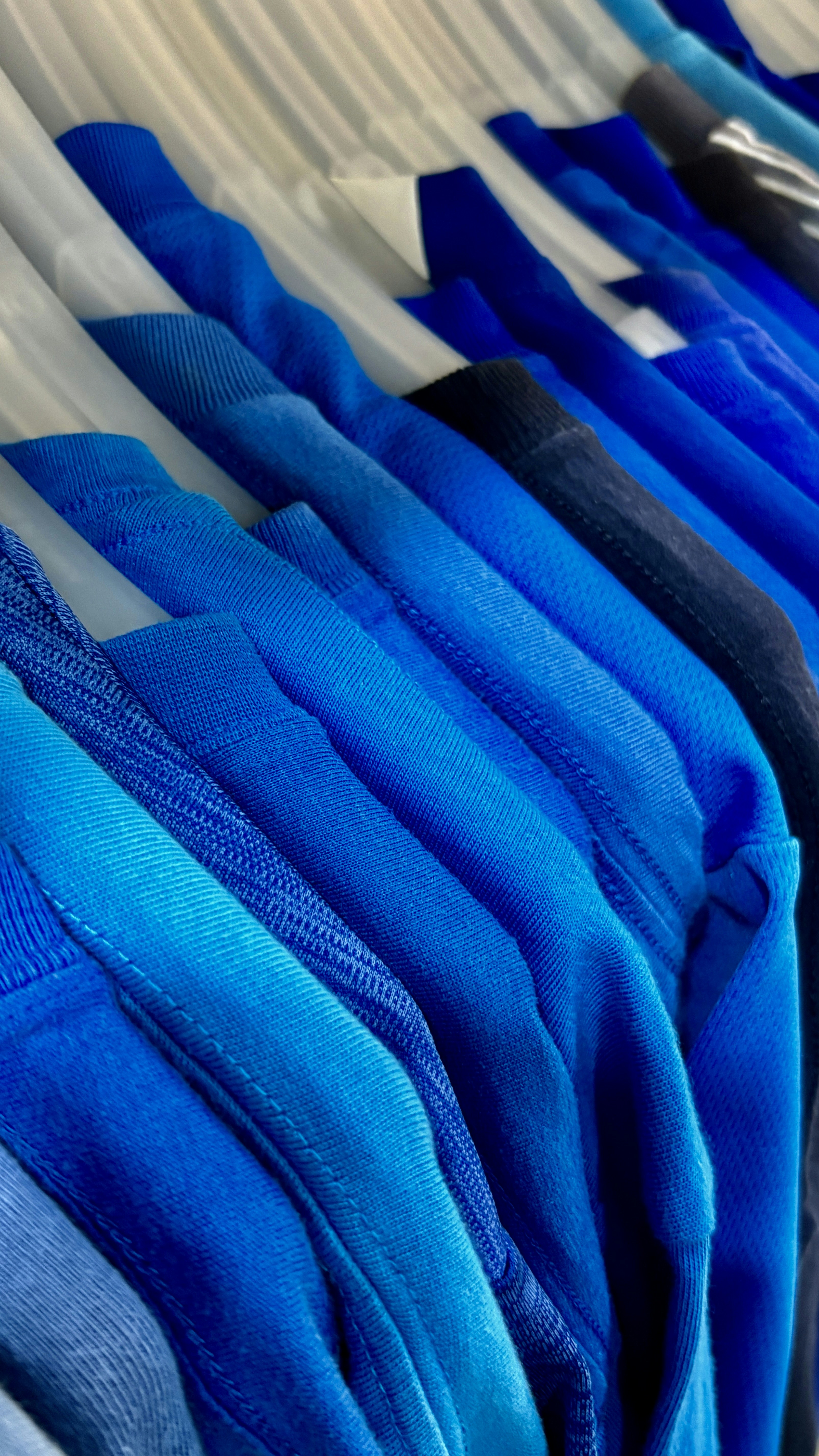 Blue shirts hanging on hangers - Free Photo on Unsplash