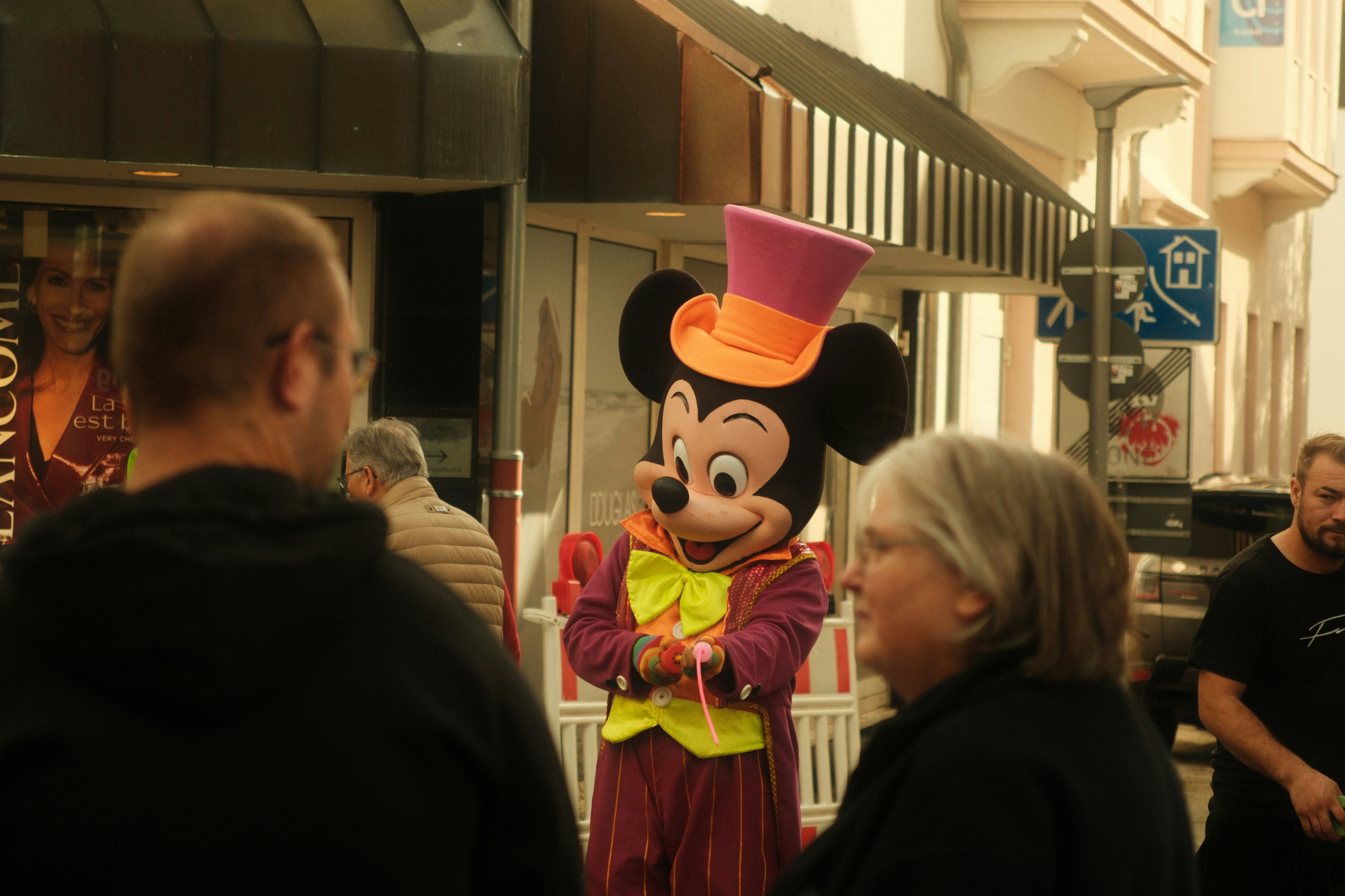 Mickey Mouse costume on city street - Free Photo on Unsplash