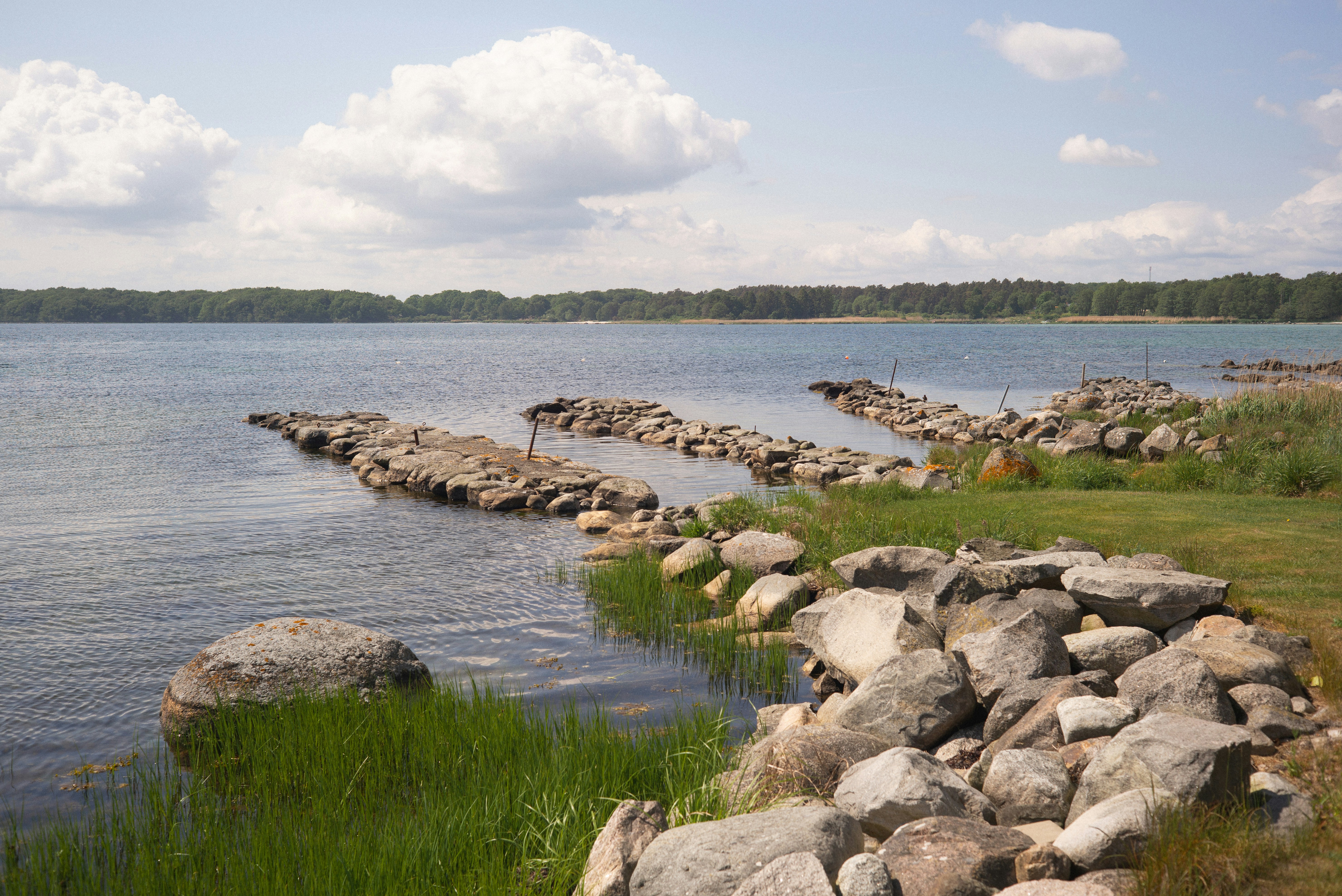Stone breakwaters in calm blue bay - Free Photo on Unsplash