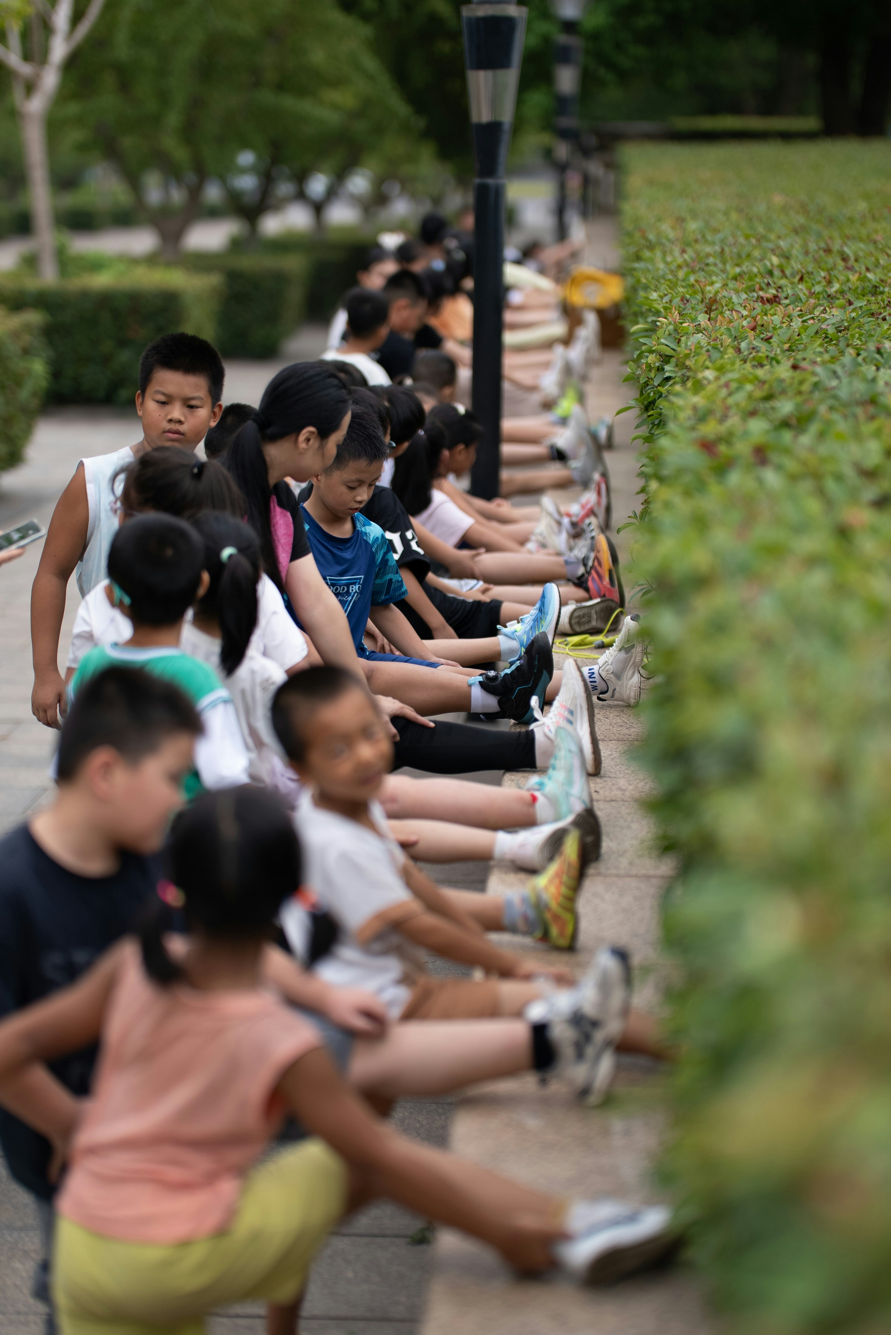 Children stretching legs on stone wall - Free Photo on Unsplash