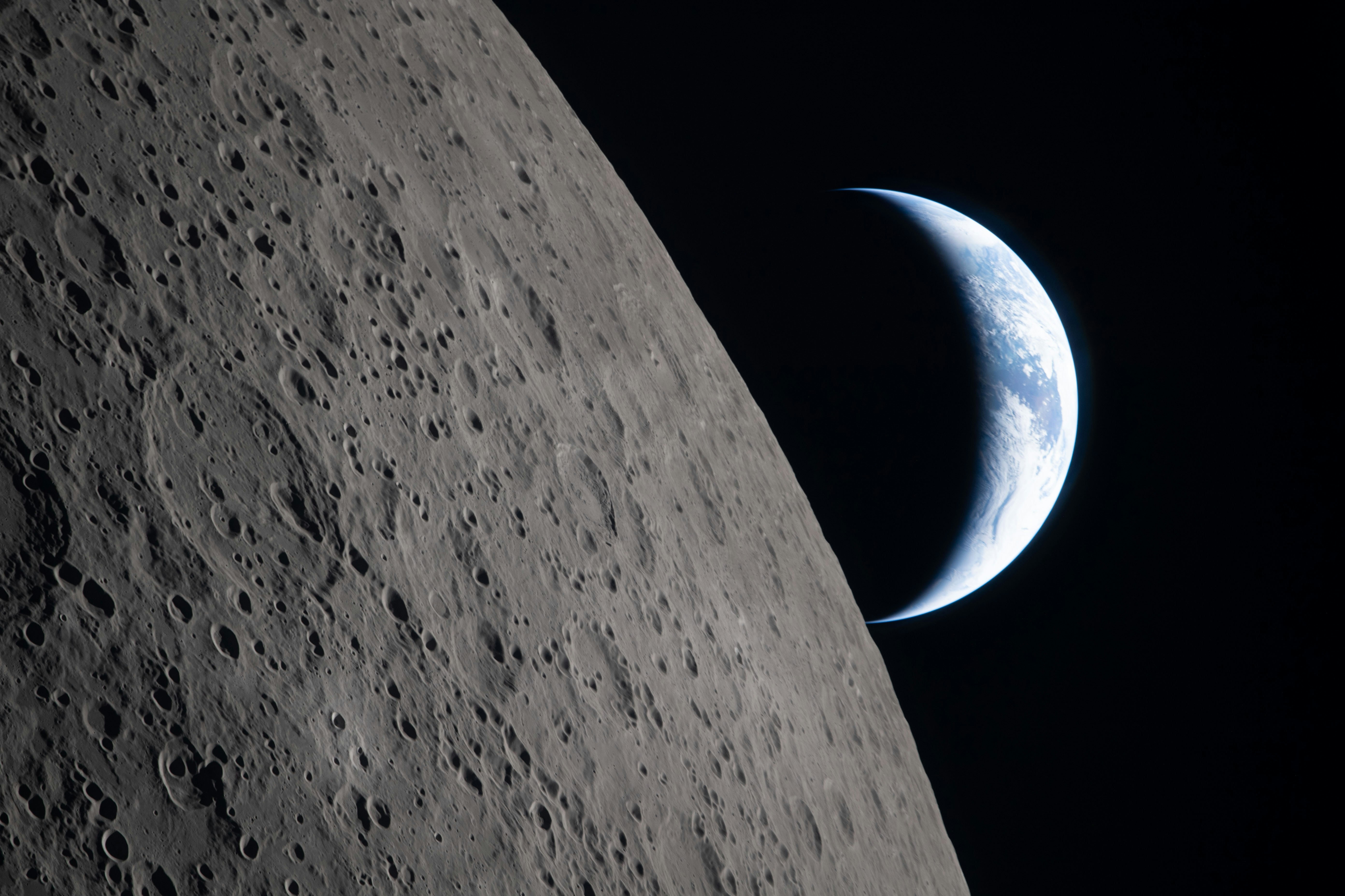 Crescent Earth rising over lunar surface - Free Photo on Unsplash