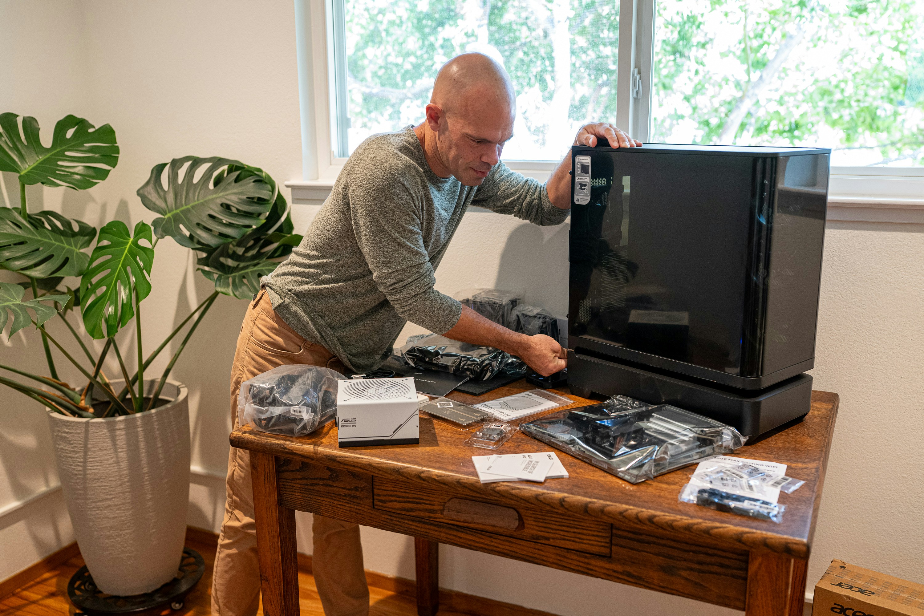 Man assembling computer on wooden desk - Free Photo on Unsplash