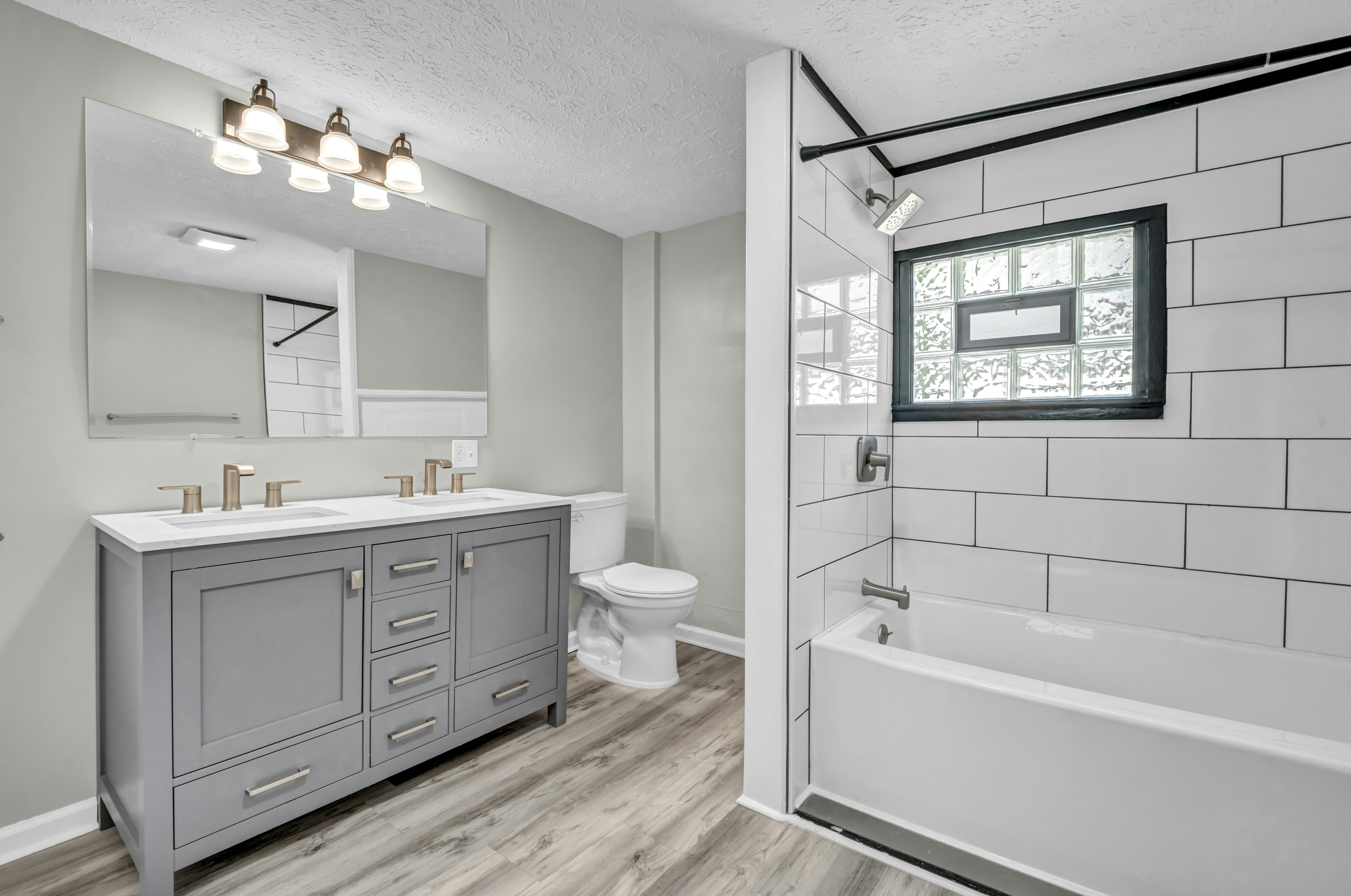 Bathroom with grey vanity and tub - Free Photo on Unsplash