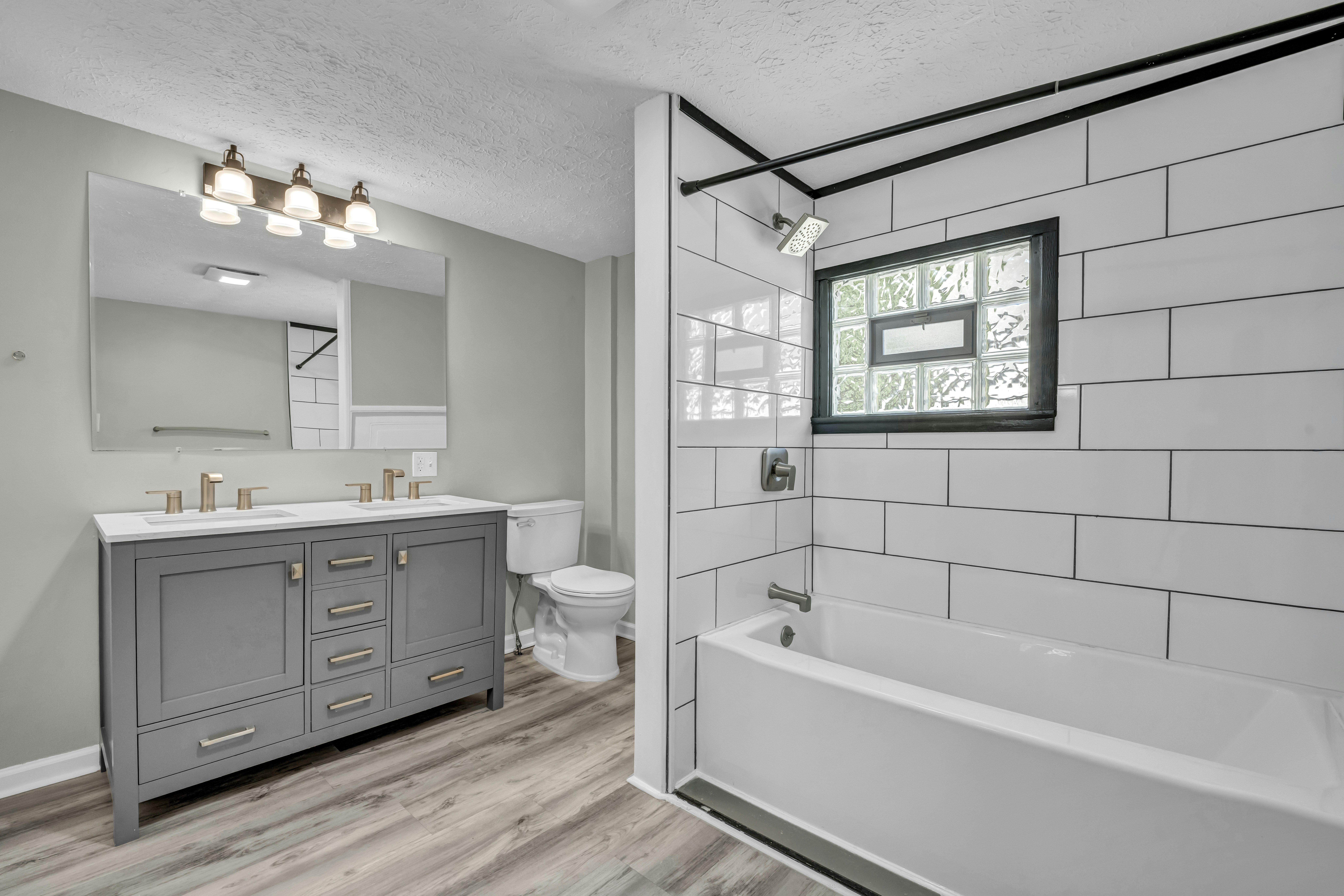 Bathroom with grey vanity and tub - Free Photo on Unsplash