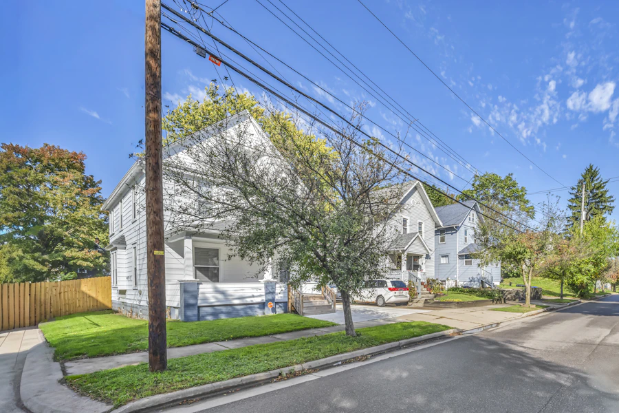 Stock photo: white house with a porch beside a blue house on a residential street