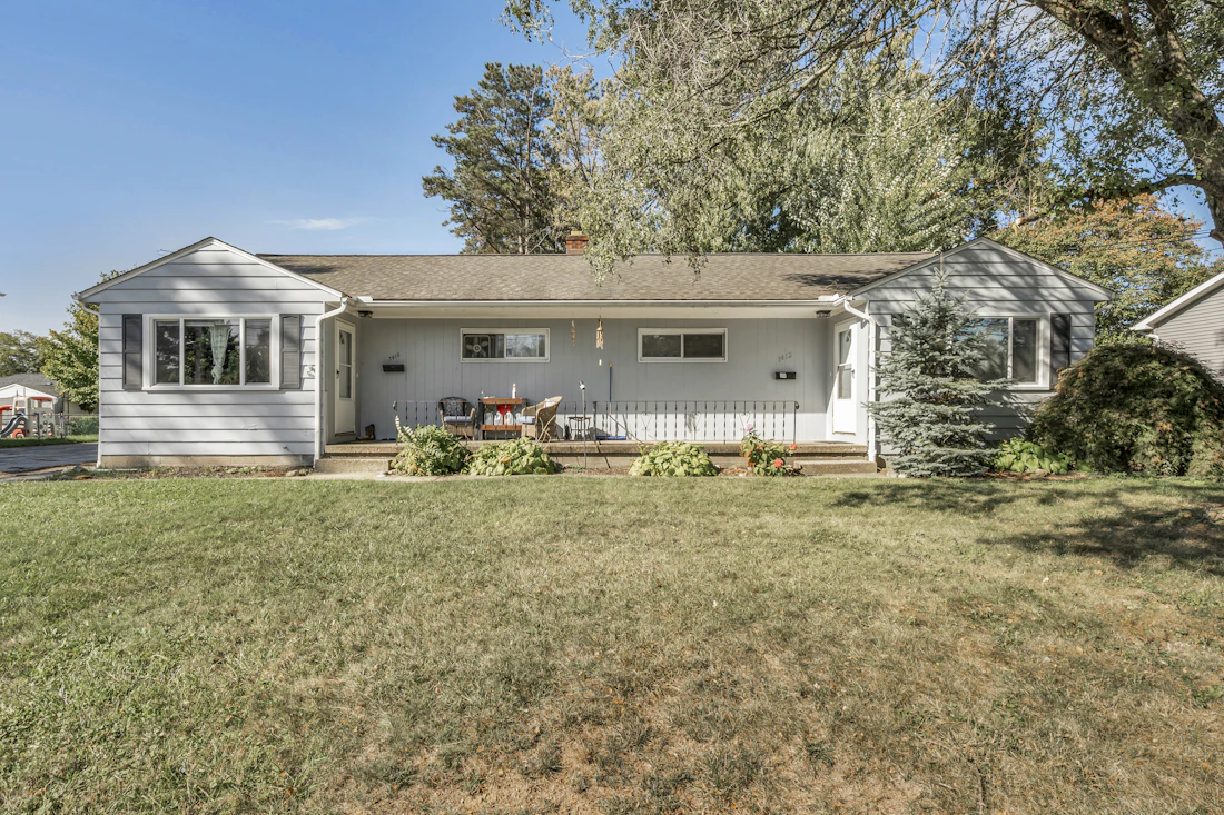Single story home with light gray siding and a front porch