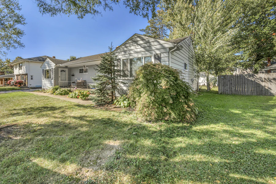 Single-story ranch house with light gray siding and a covered front porch