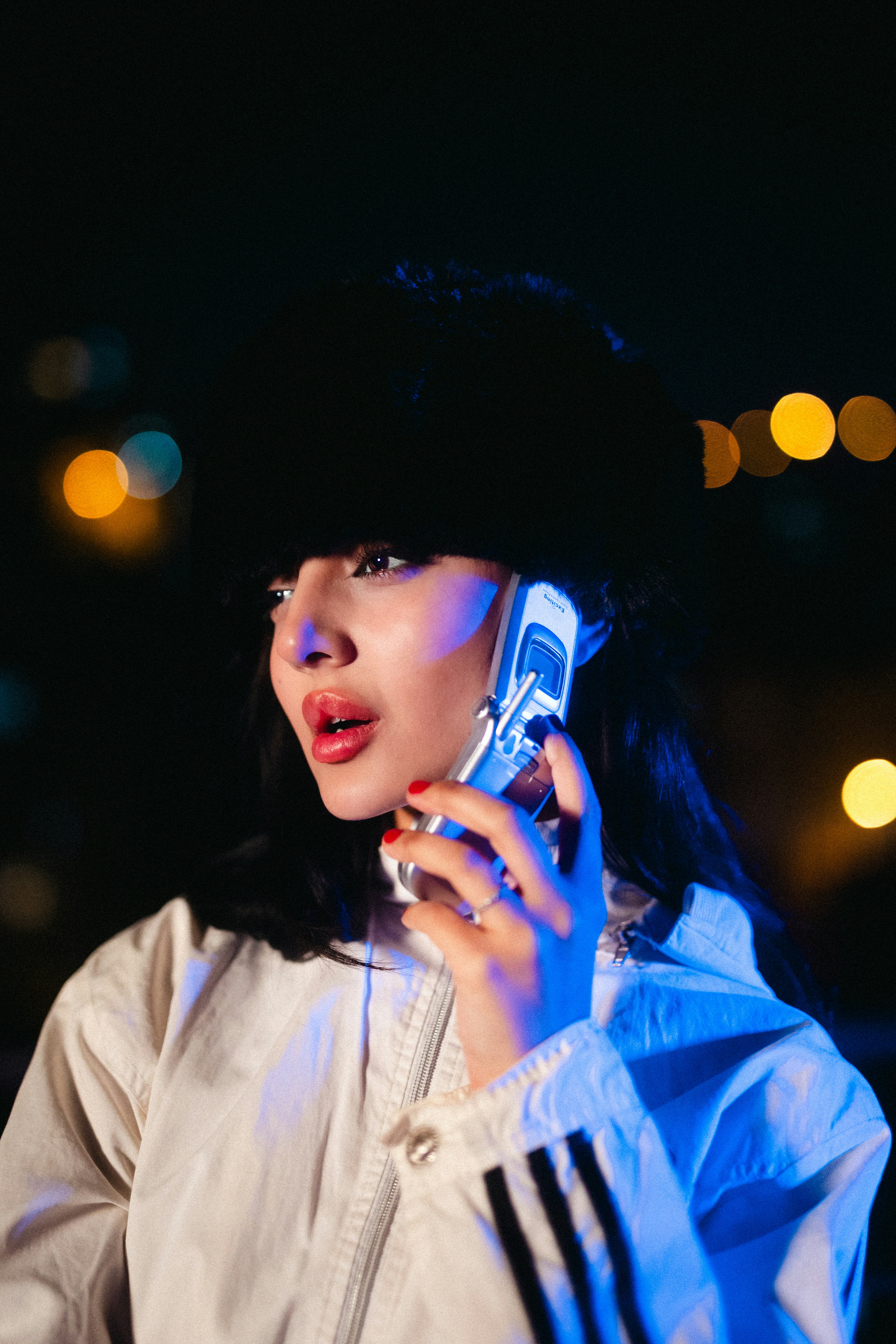 Woman talking on flip phone at night - Free Photo on Unsplash