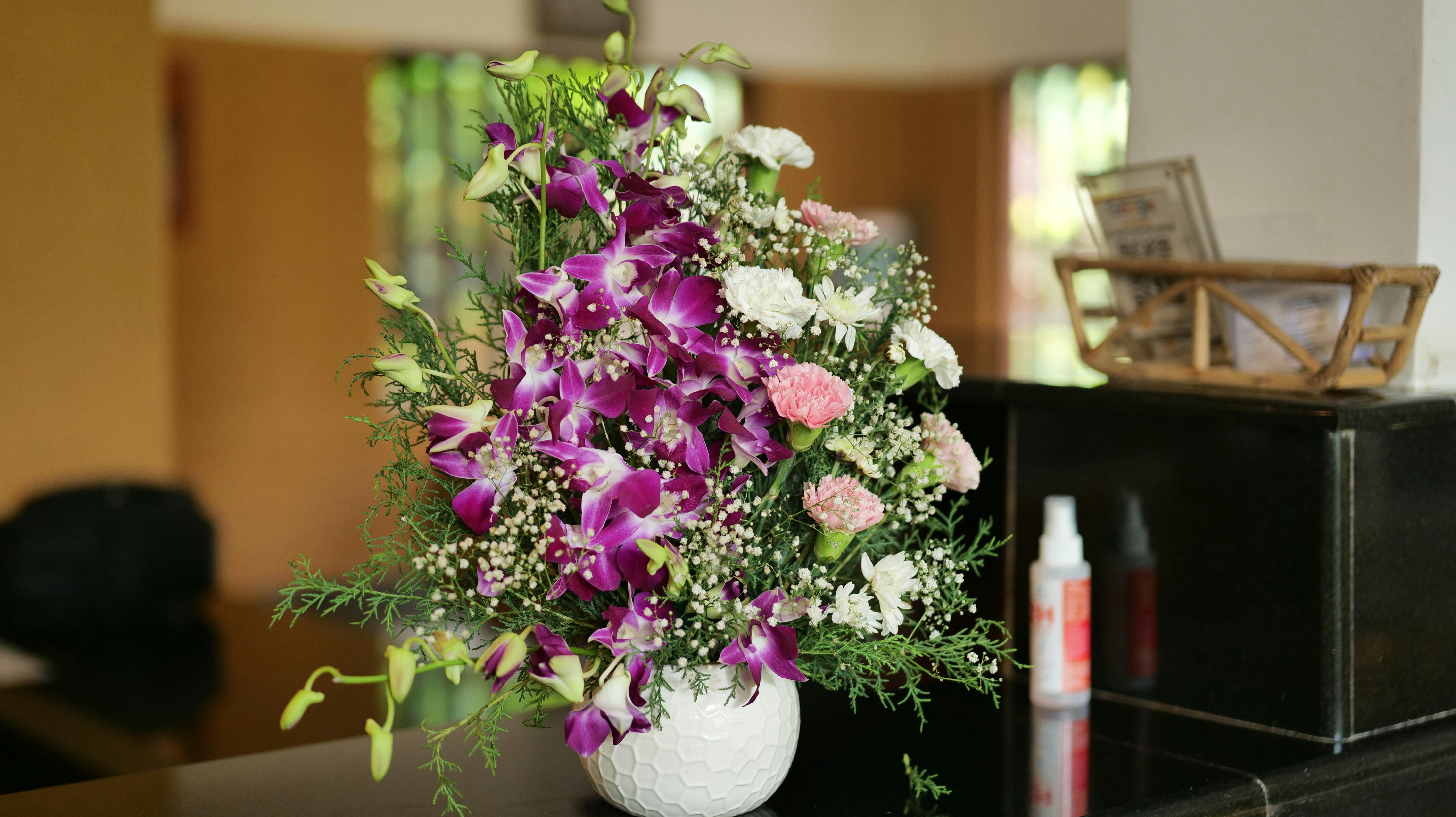 Floral arrangement of orchids and carnations - Free Photo on Unsplash