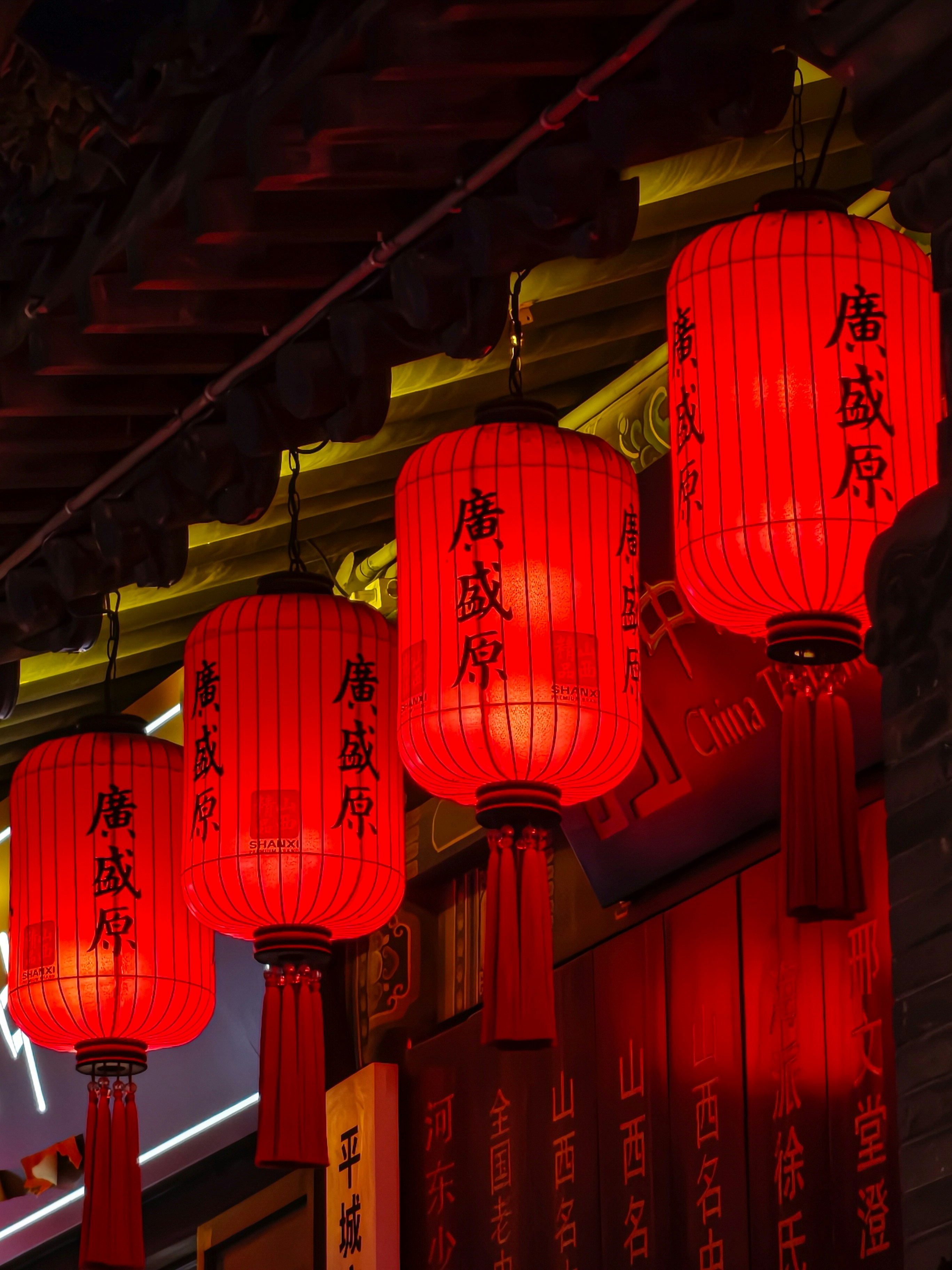 Glowing red lanterns on tiled roof - Free Photo on Unsplash