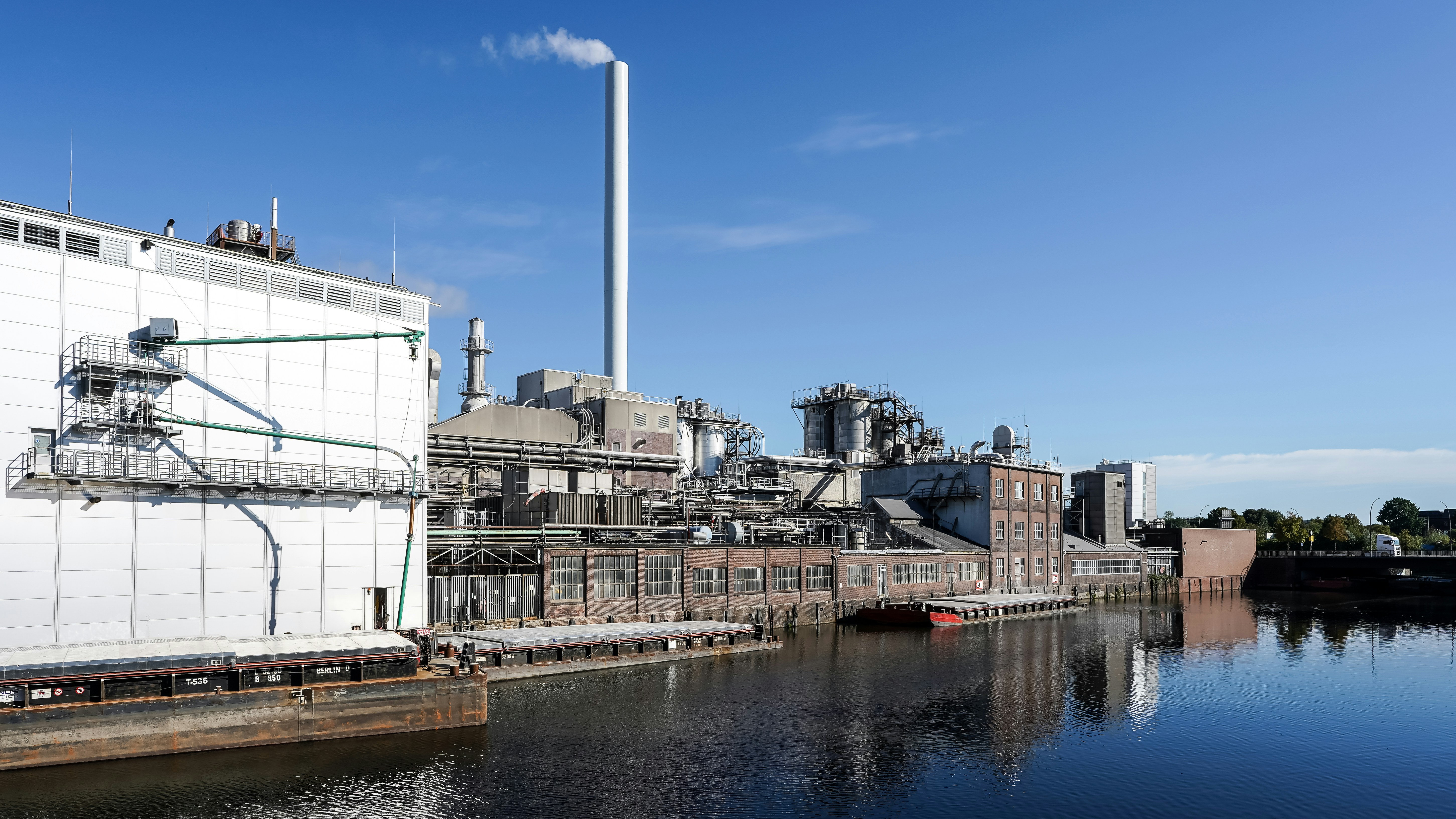 Industrial factory beside calm river - Free Photo on Unsplash