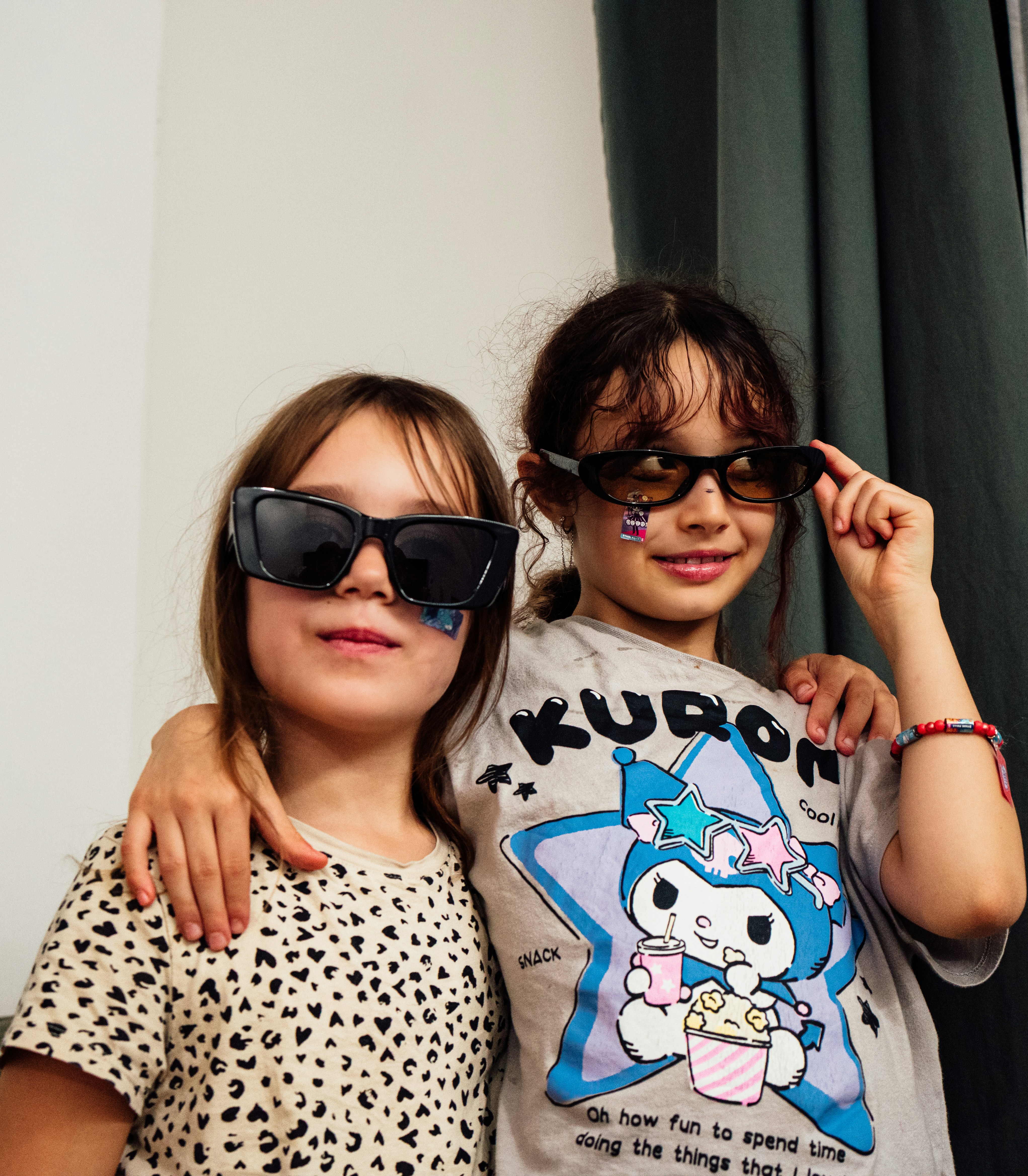 Two children wearing sunglasses and stickers - Free Photo on Unsplash