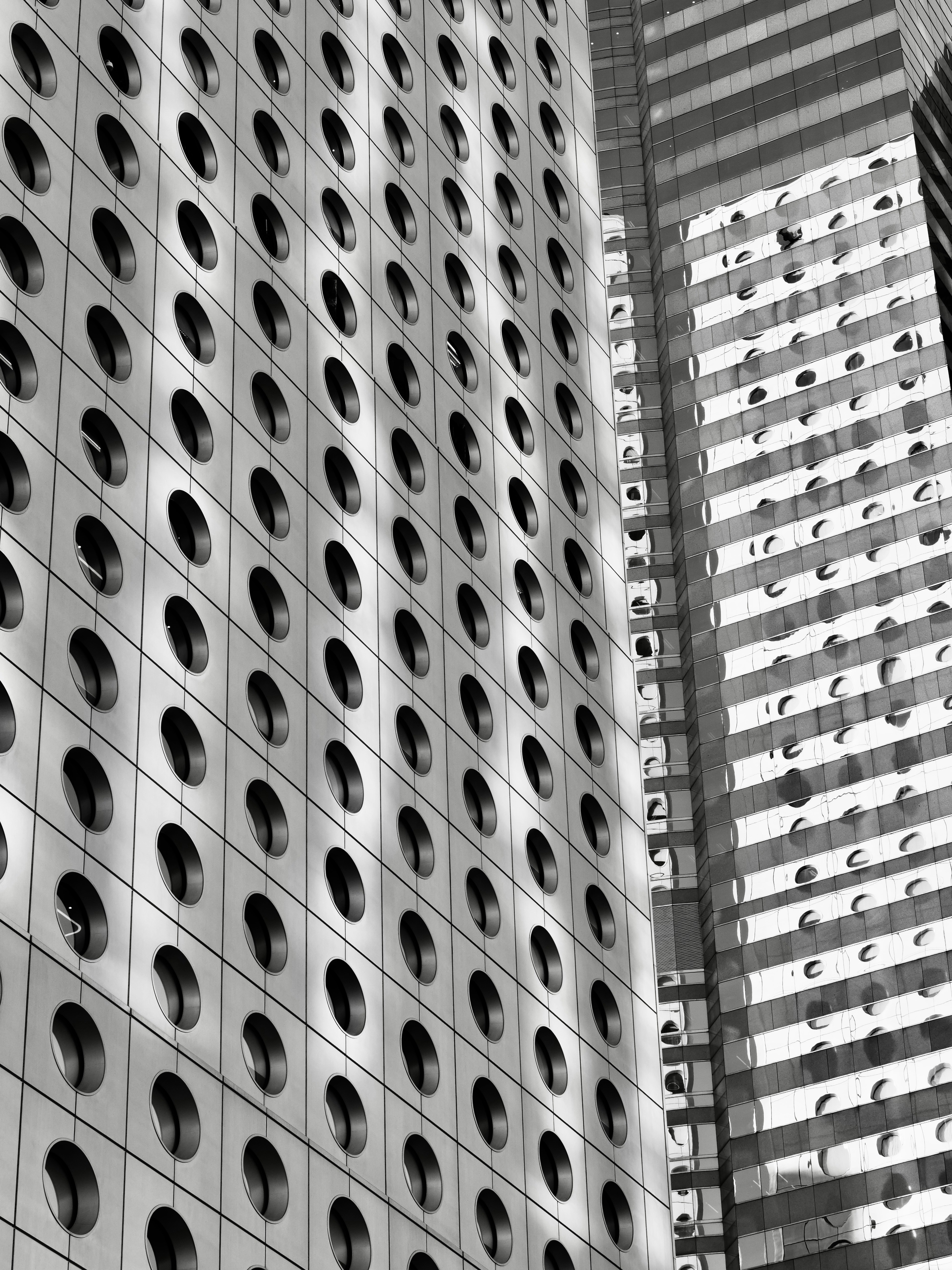 Modern skyscraper facade with circular windows - Free Photo on Unsplash