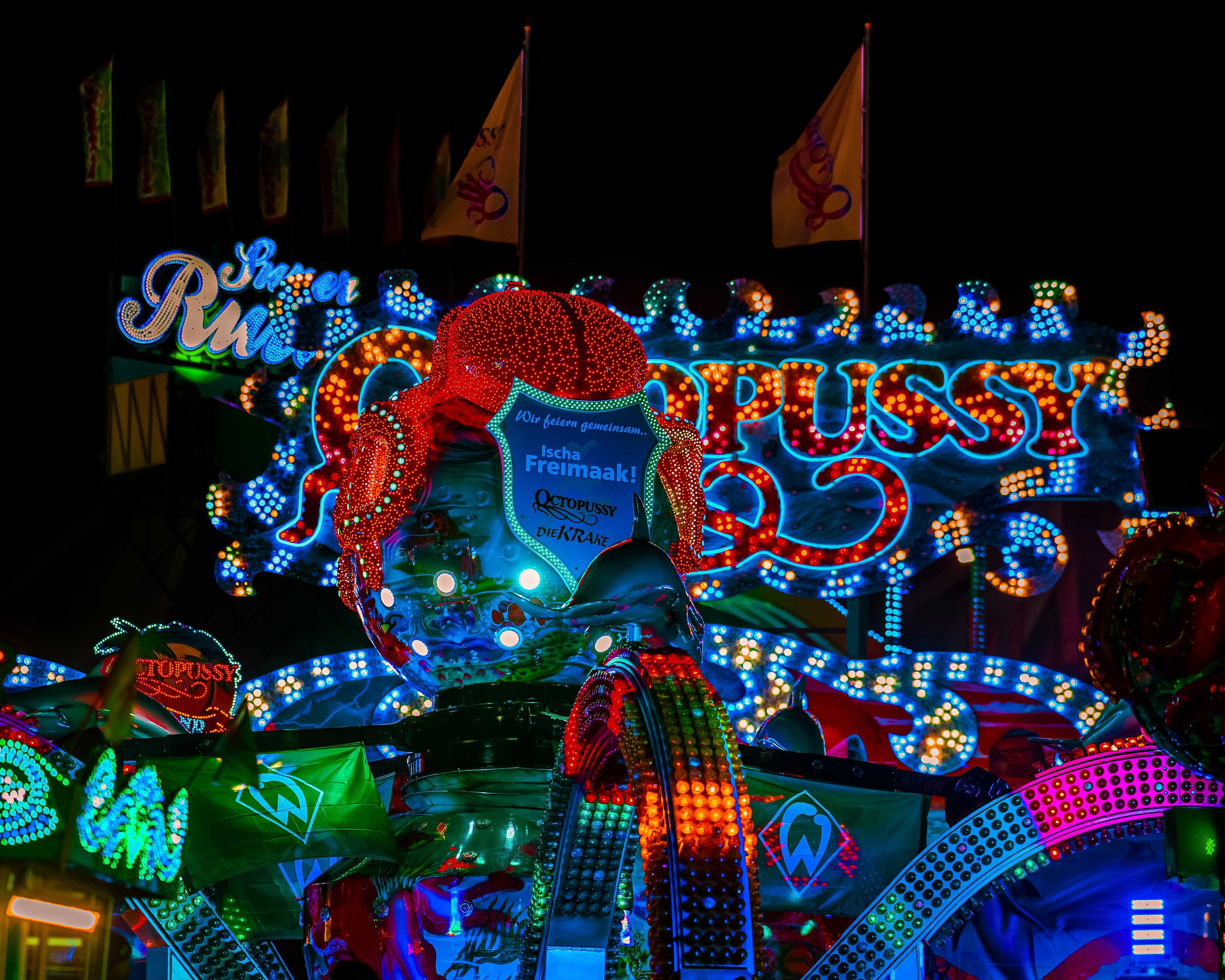 Neon carnival ride with octopus signage - Free Photo on Unsplash