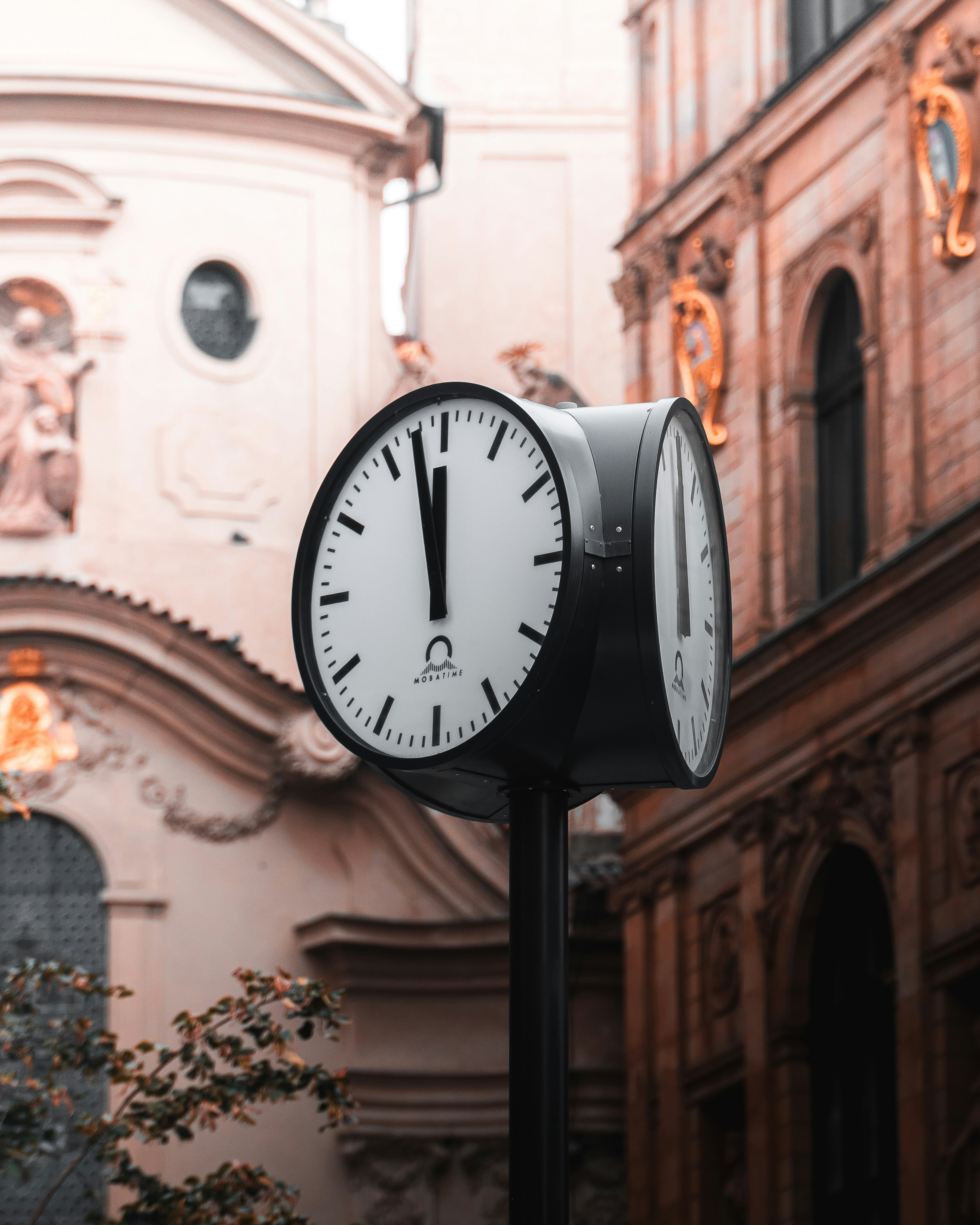 Street clock in front of buildings - Free Photo on Unsplash