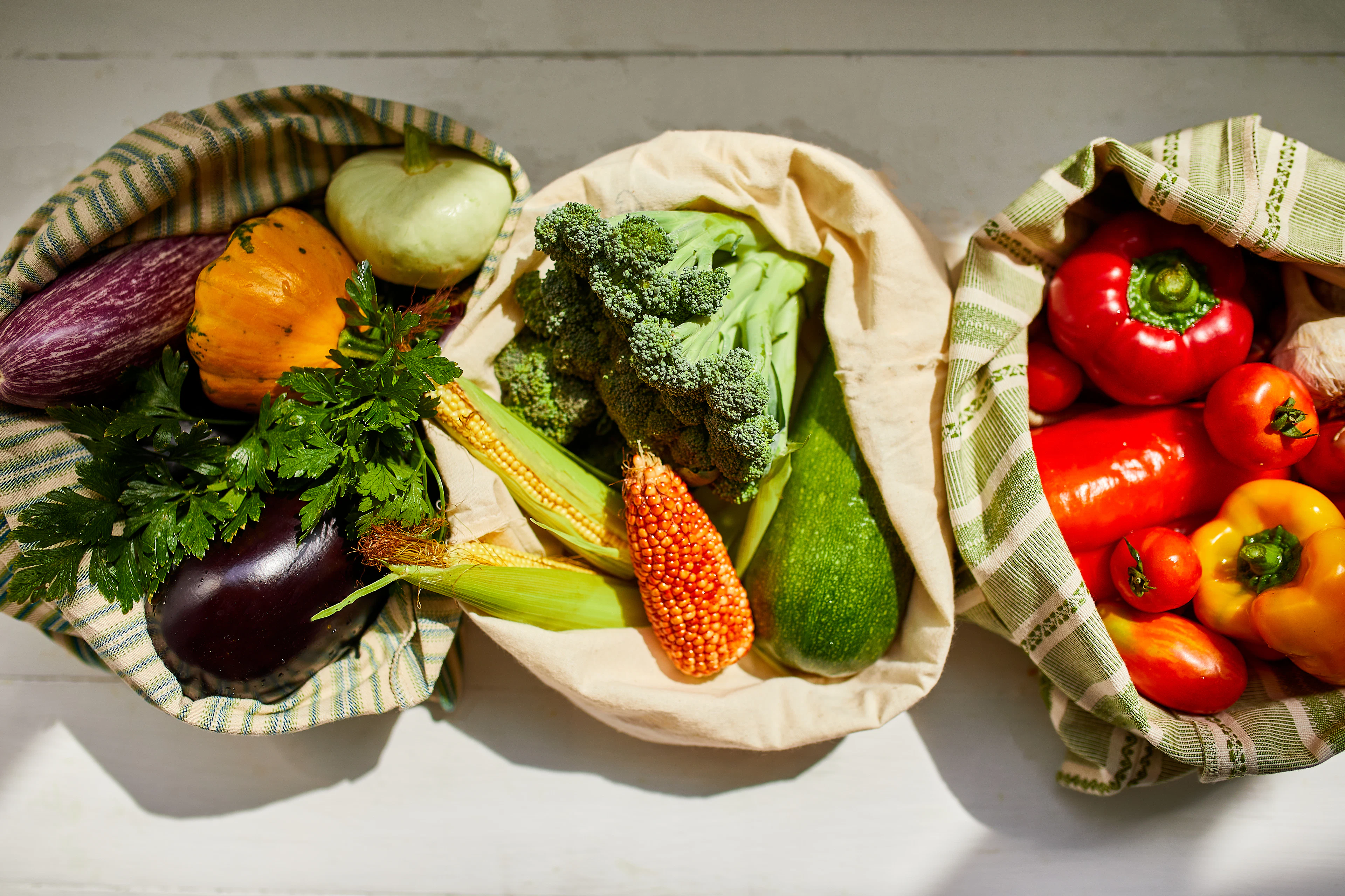 Cloth bags full of fresh vegetables